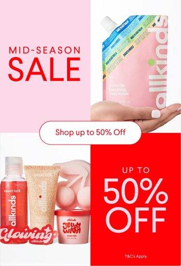a woman is holding a bottle of lotion in her hand .