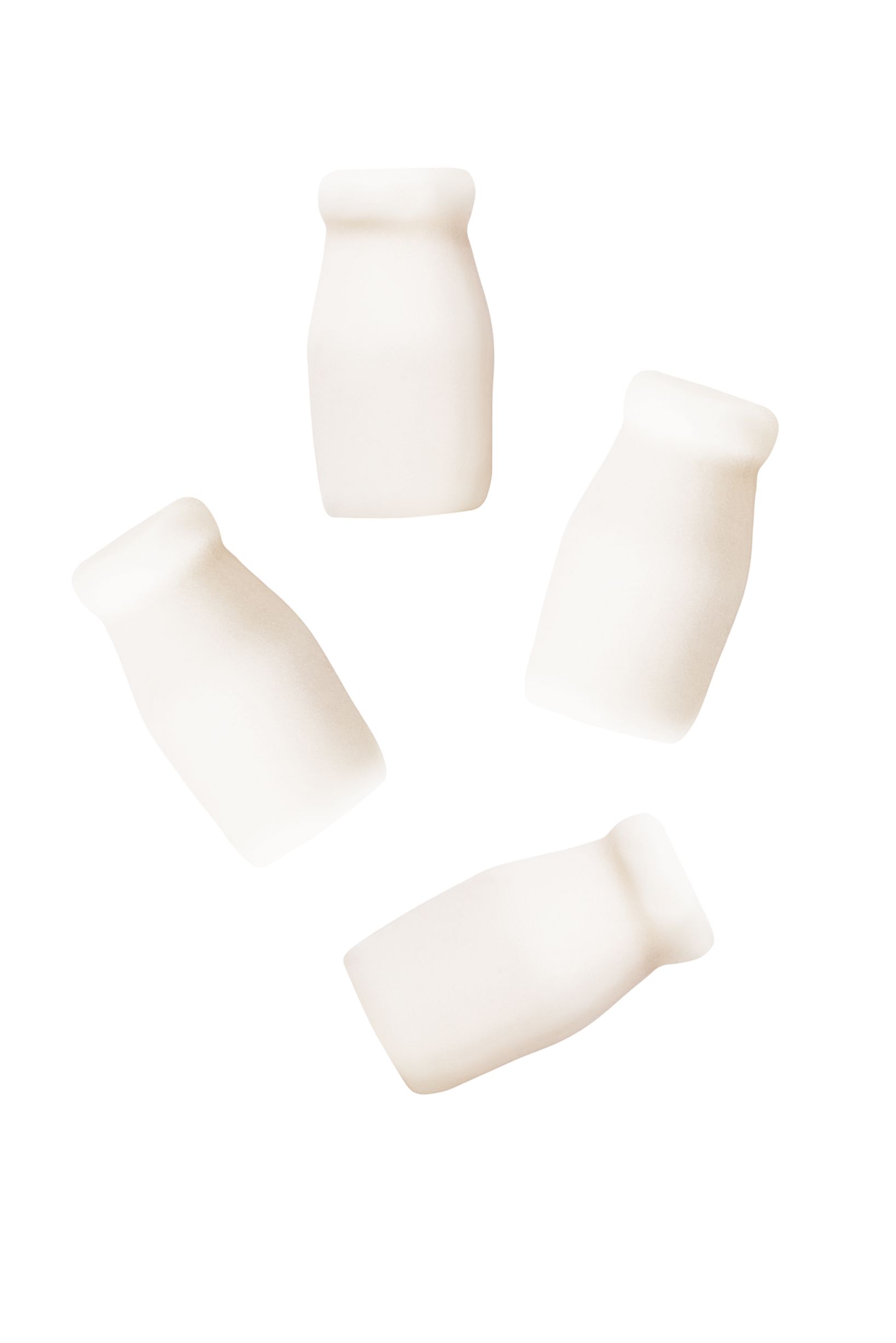four white bottles are floating in the air on a white background