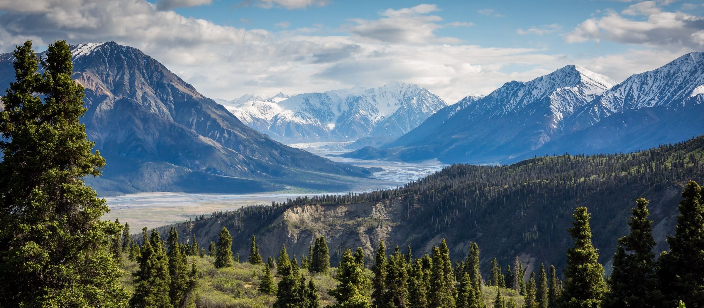 Soaring view of a waterfall against a beautiful green landscape