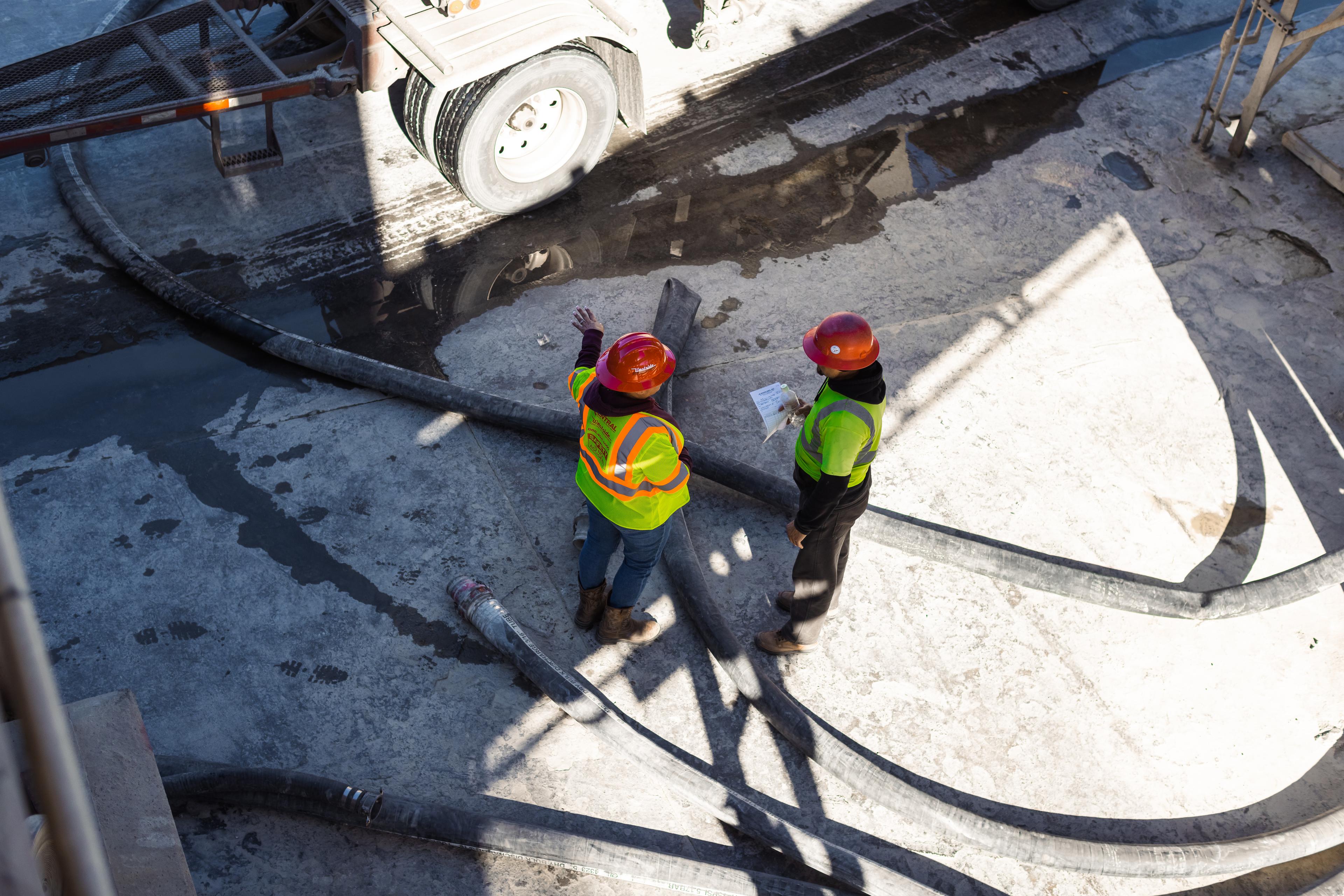 construction workers inspect a work site