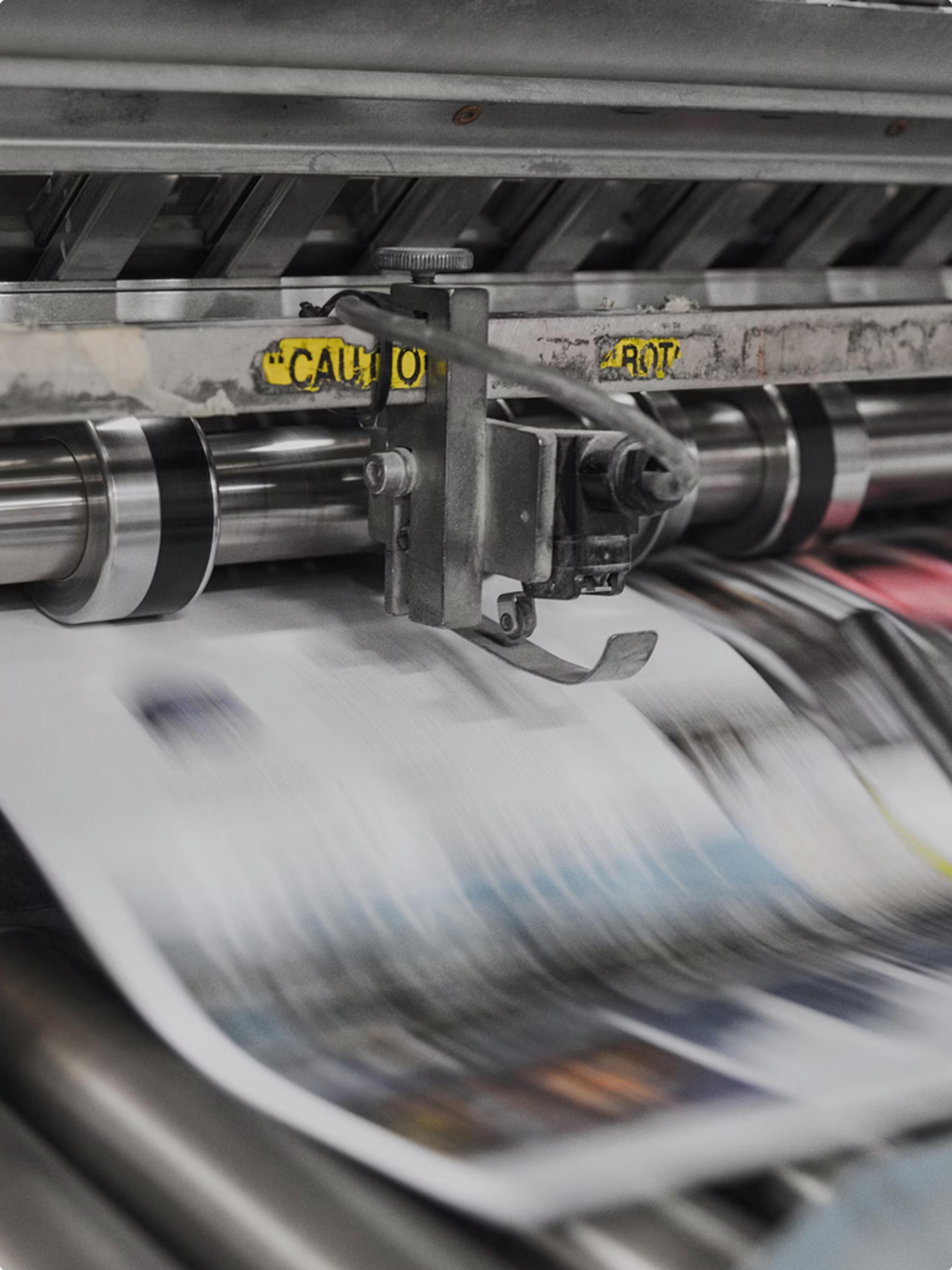 A printing press showing paper for a publication printed