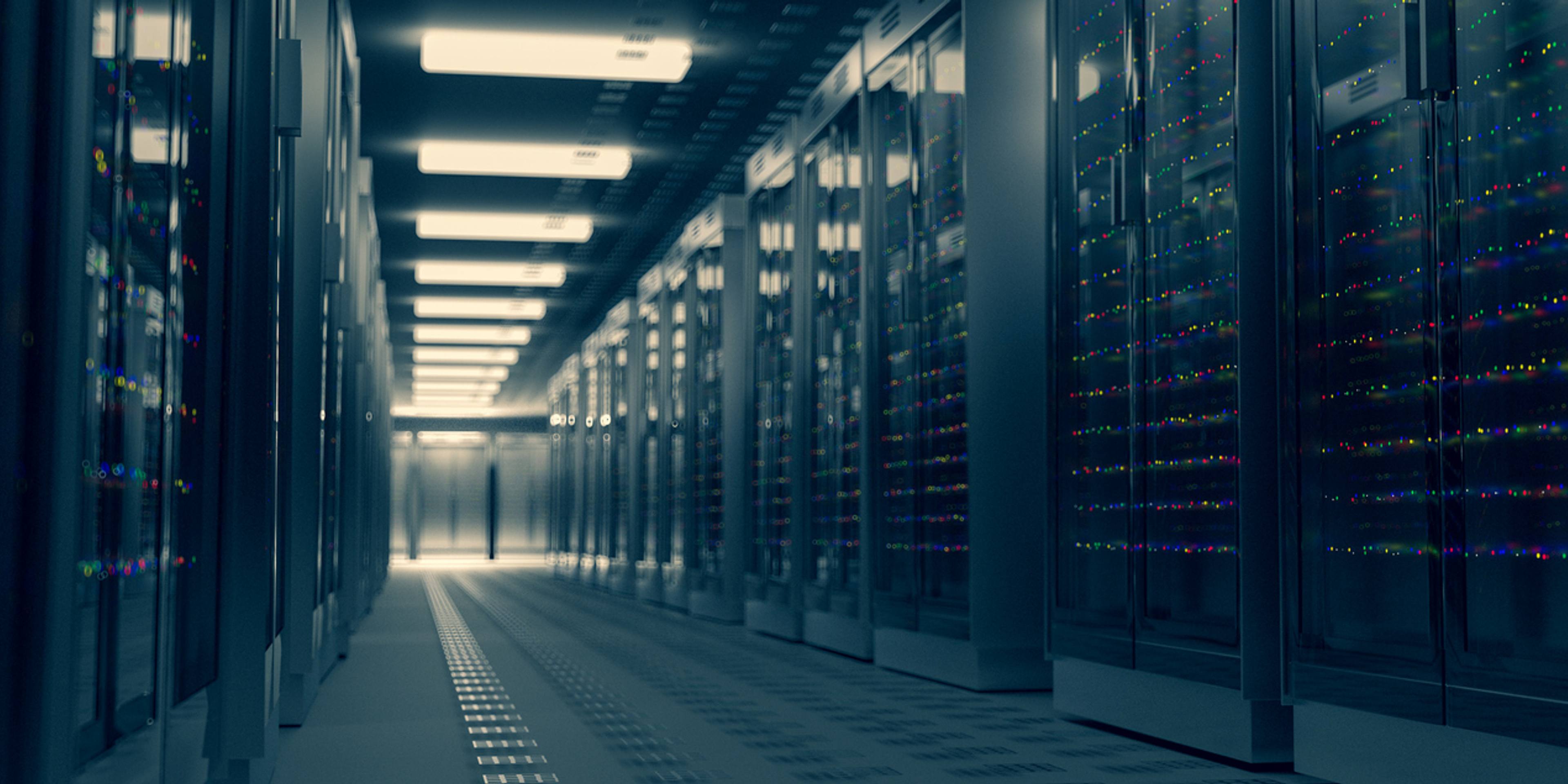 Server racks glowing in a dark data center