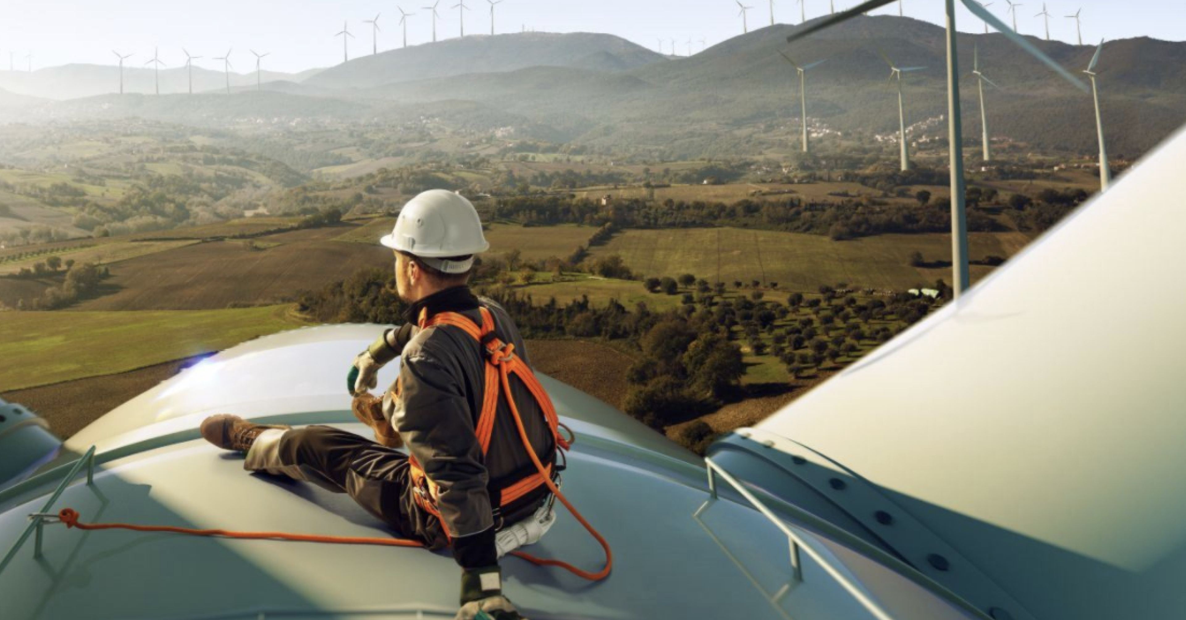 Construction worker looking at windmills