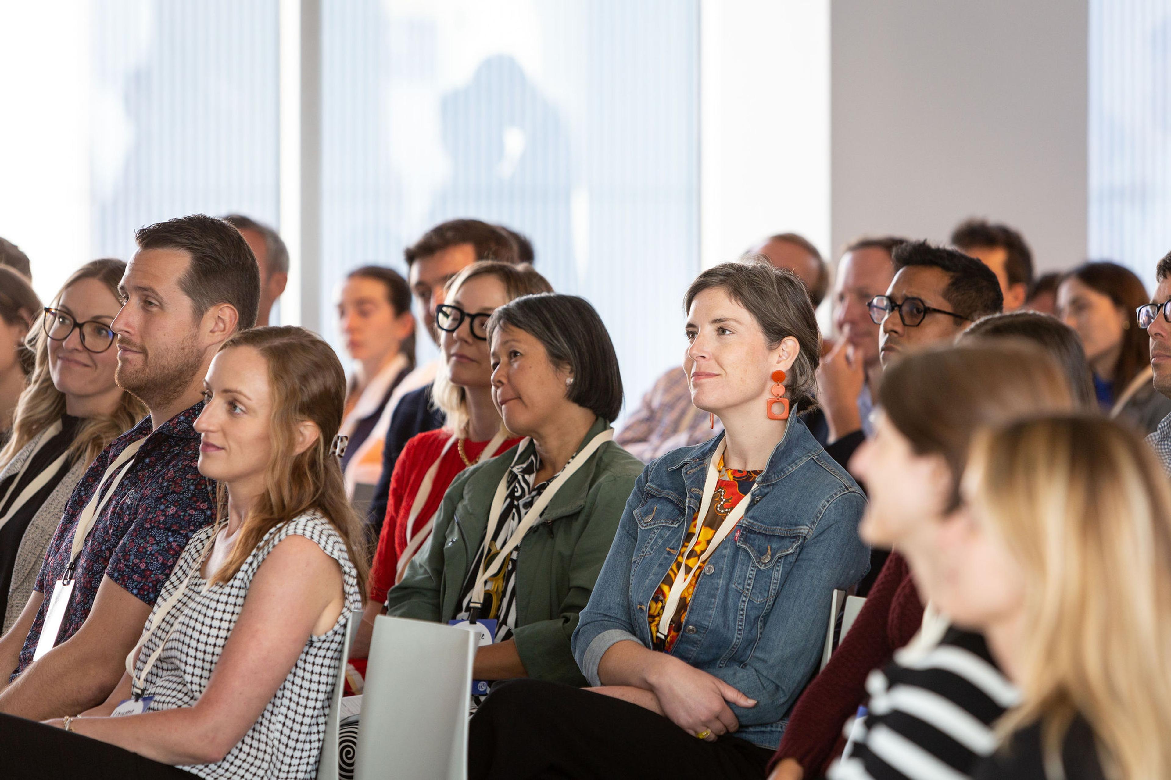 Conference goers listening to a presentation