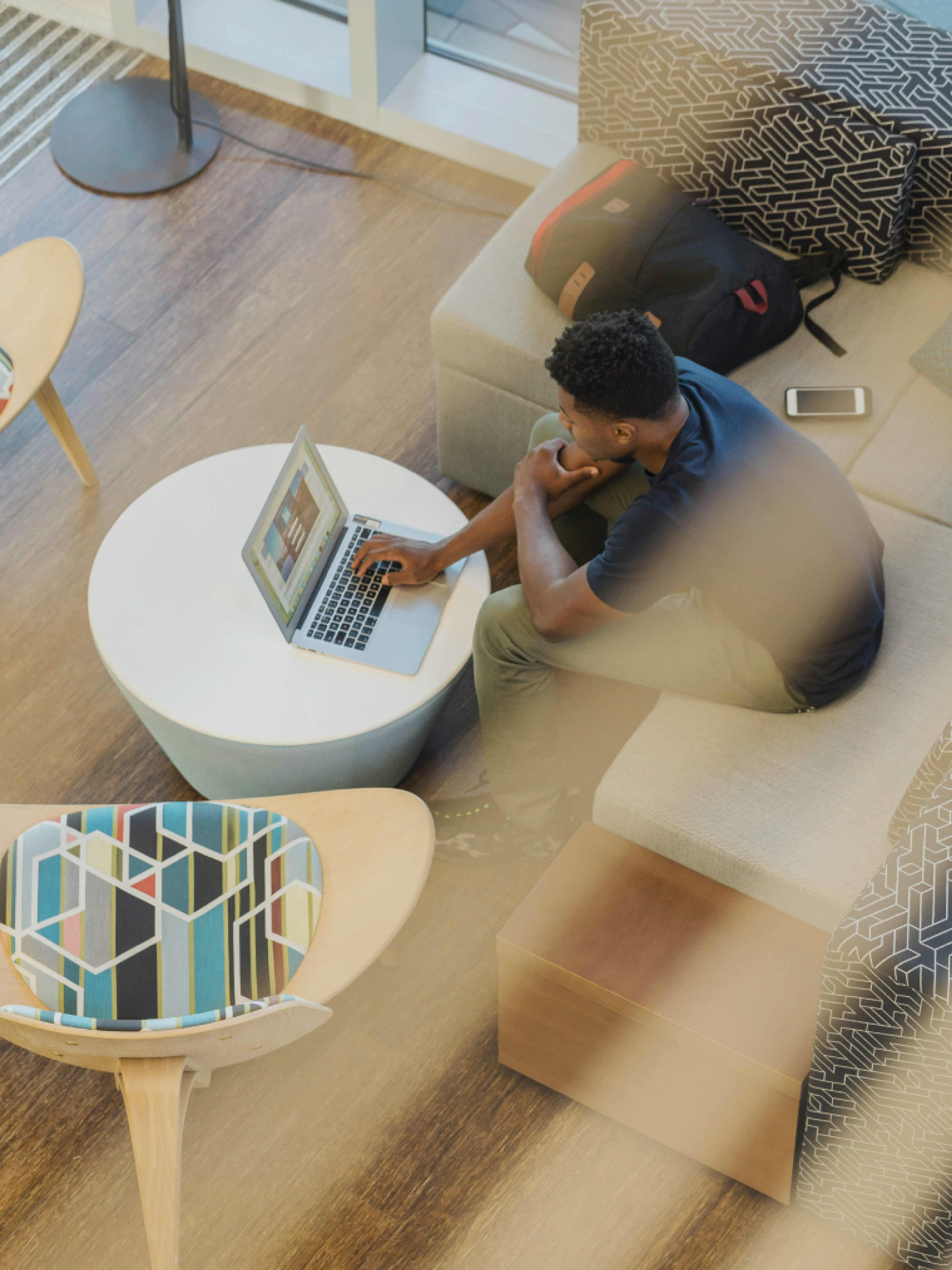 A person working on a laptop in a lounge