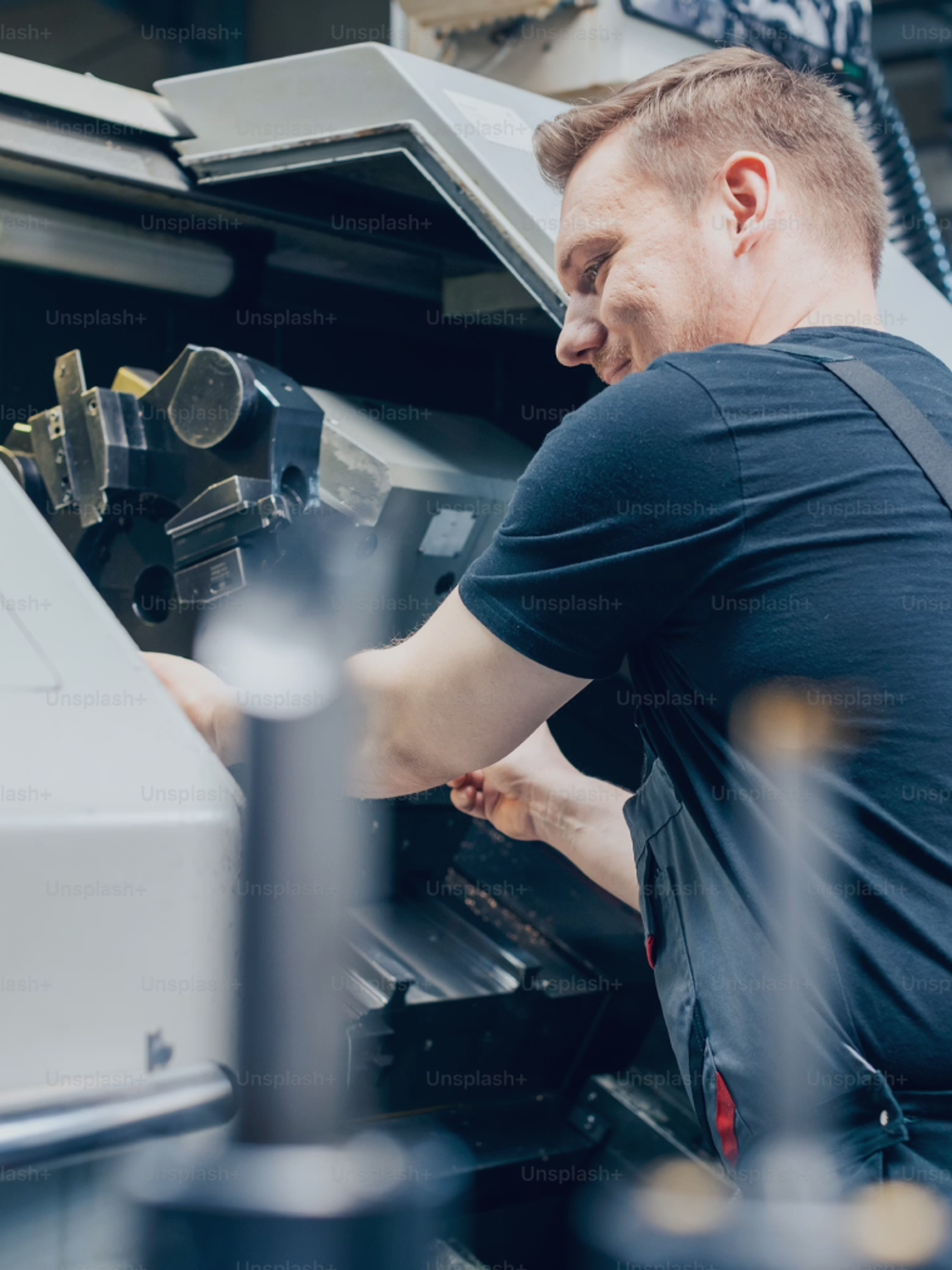 An engineer working at an industrial machine