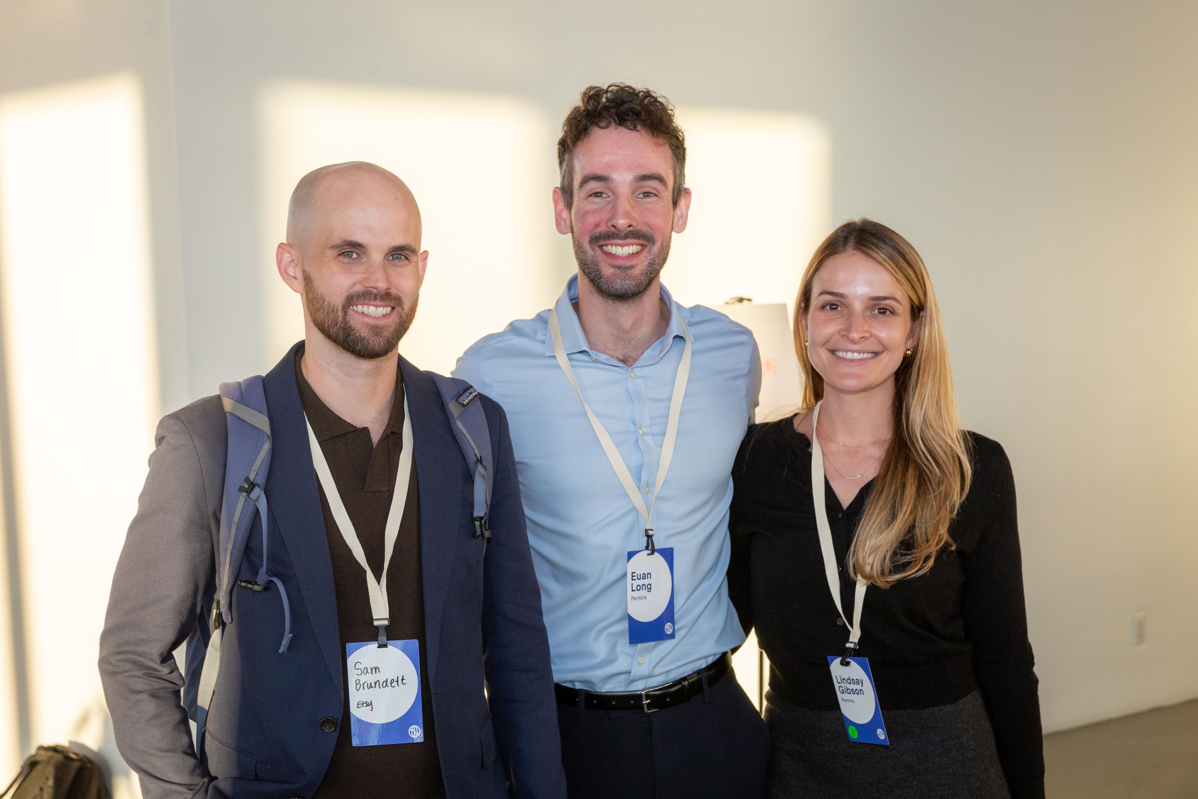 Three attendees arm in arm