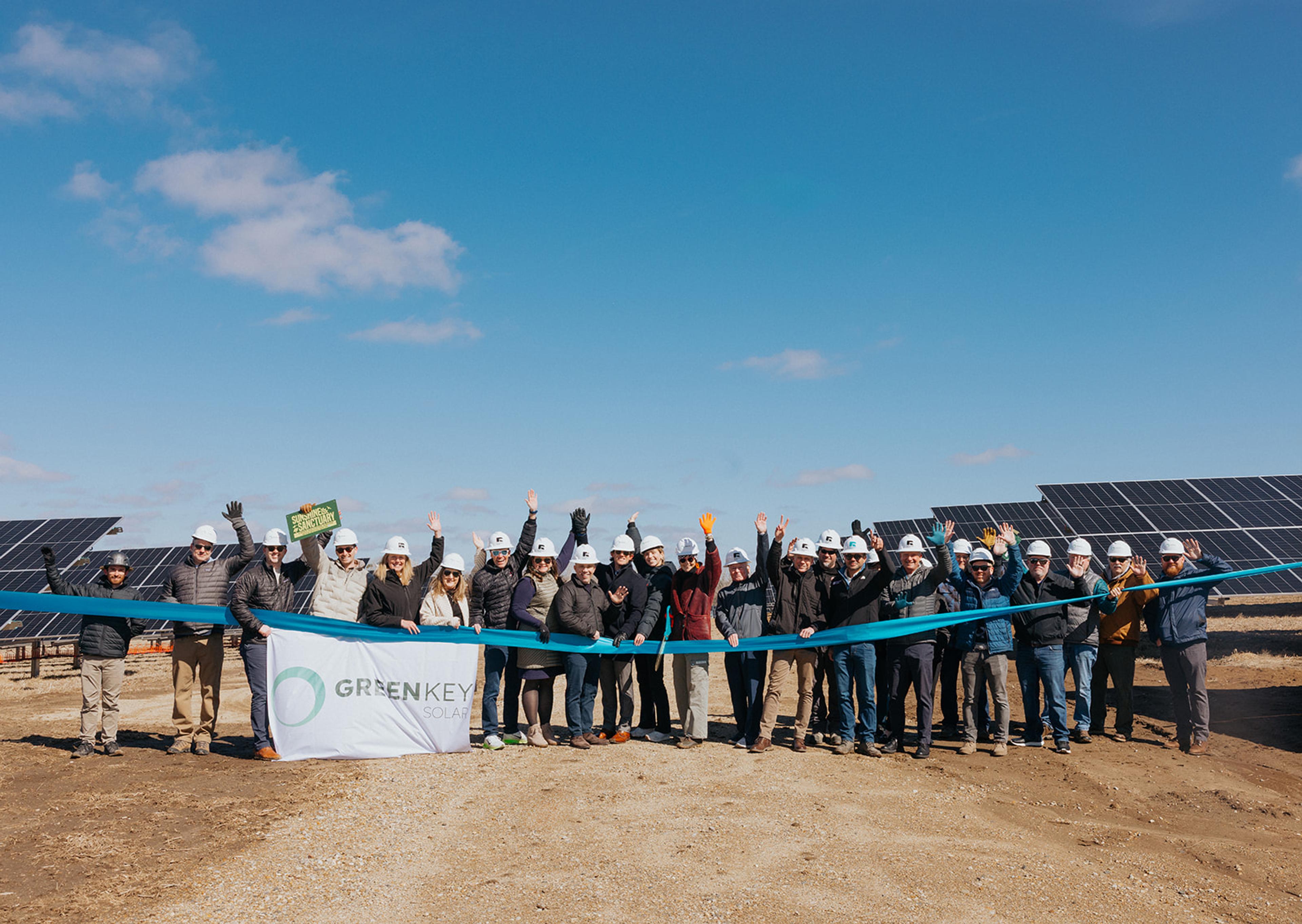 people gathered in front of solar panels