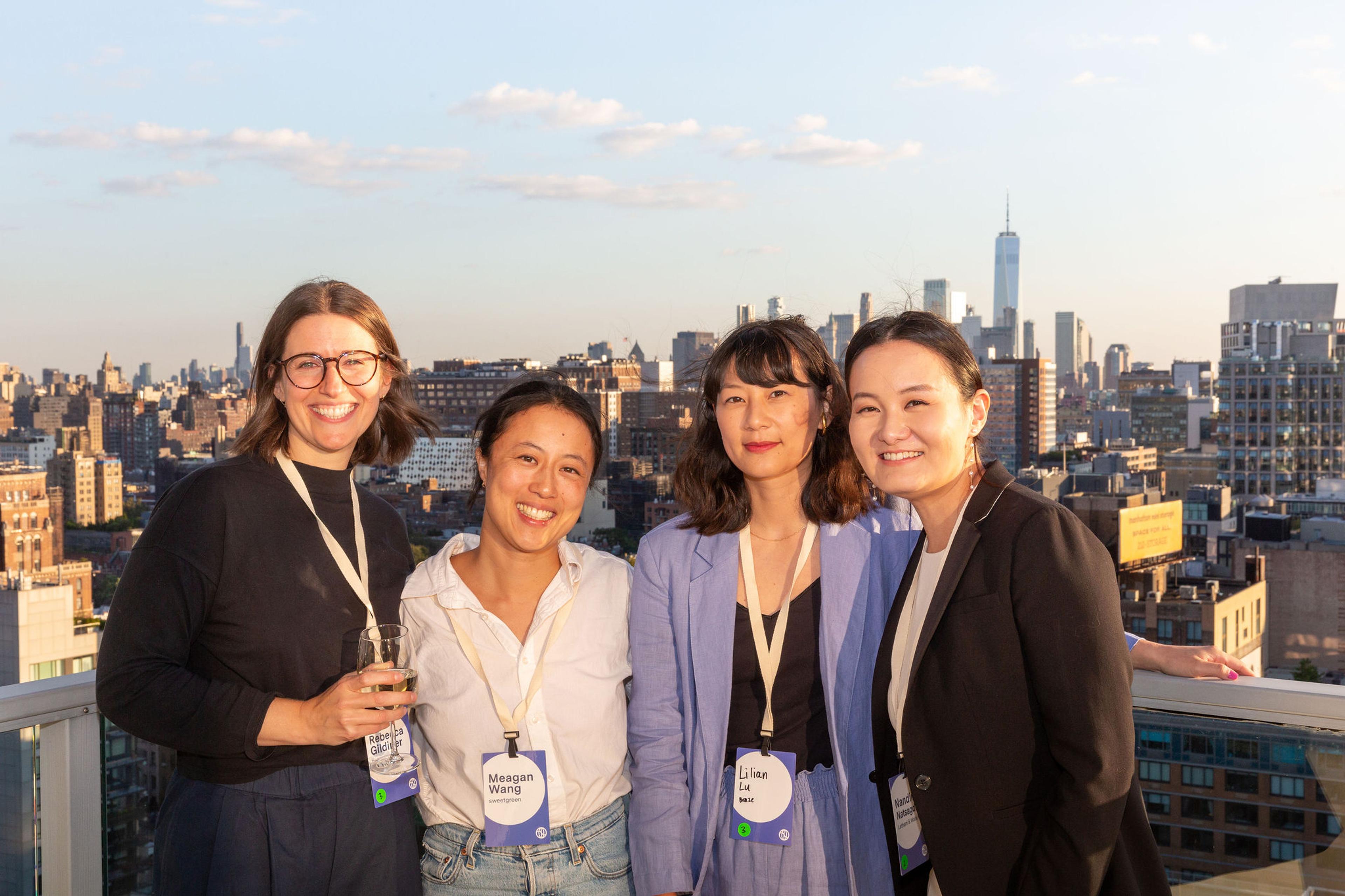4 women on a rooftop with conference badges