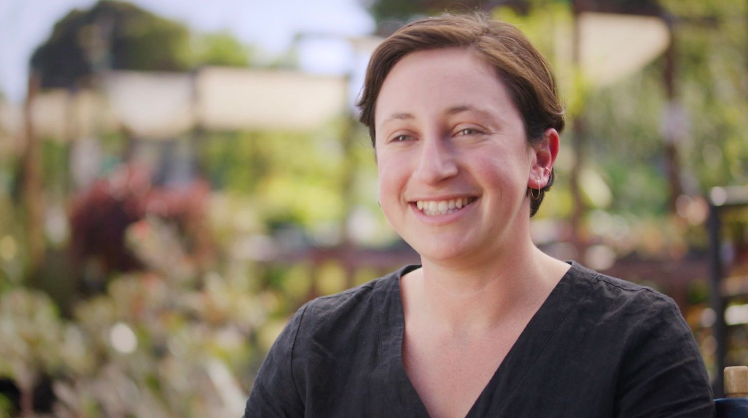 Frame of video showing Maddy Rotman of Imperfect Foods speaking on a farm