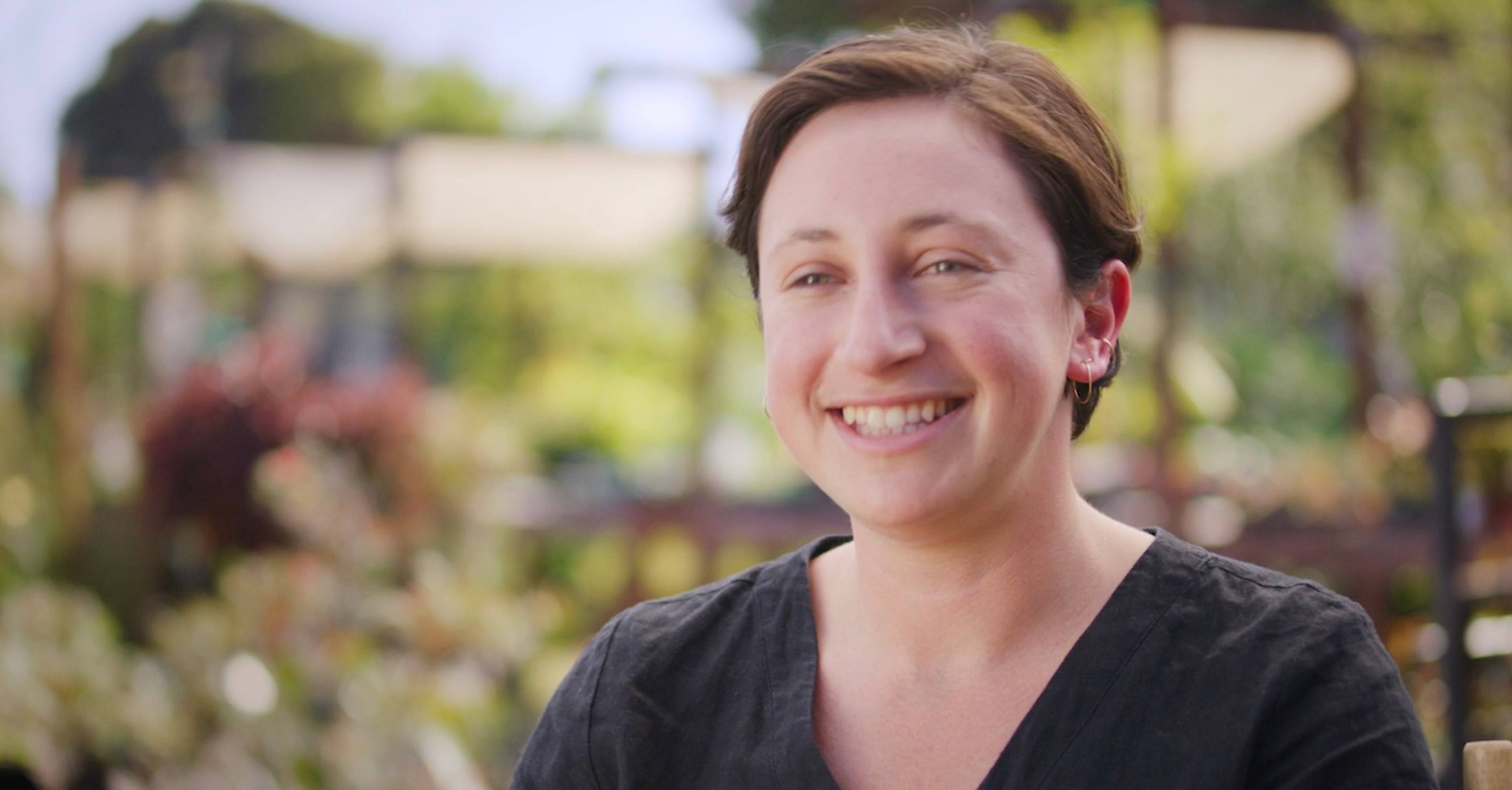 Frame of video showing Maddy Rotman of Imperfect Foods speaking on a farm