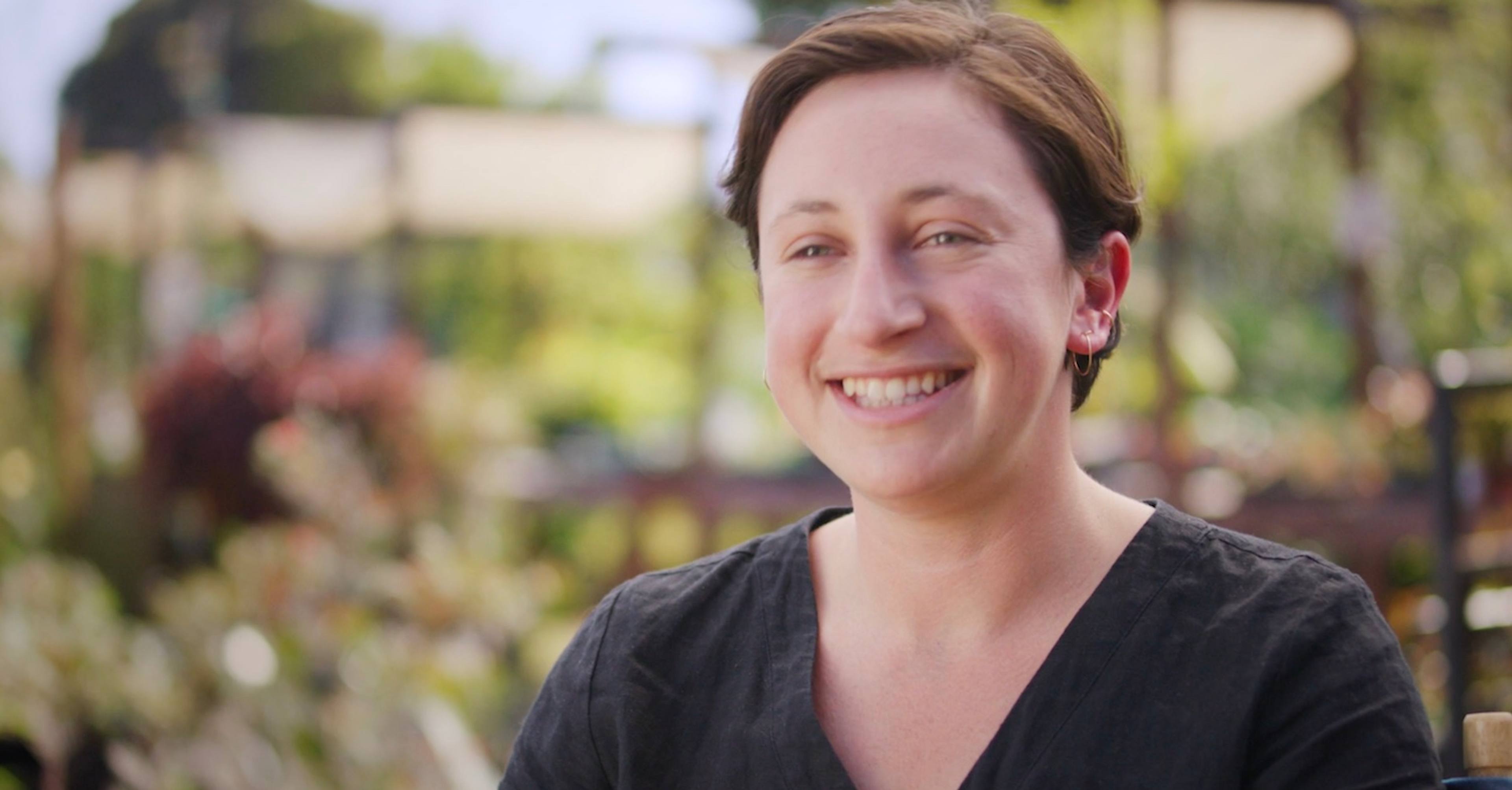 Frame of video showing Maddy Rotman of Imperfect Foods speaking on a farm