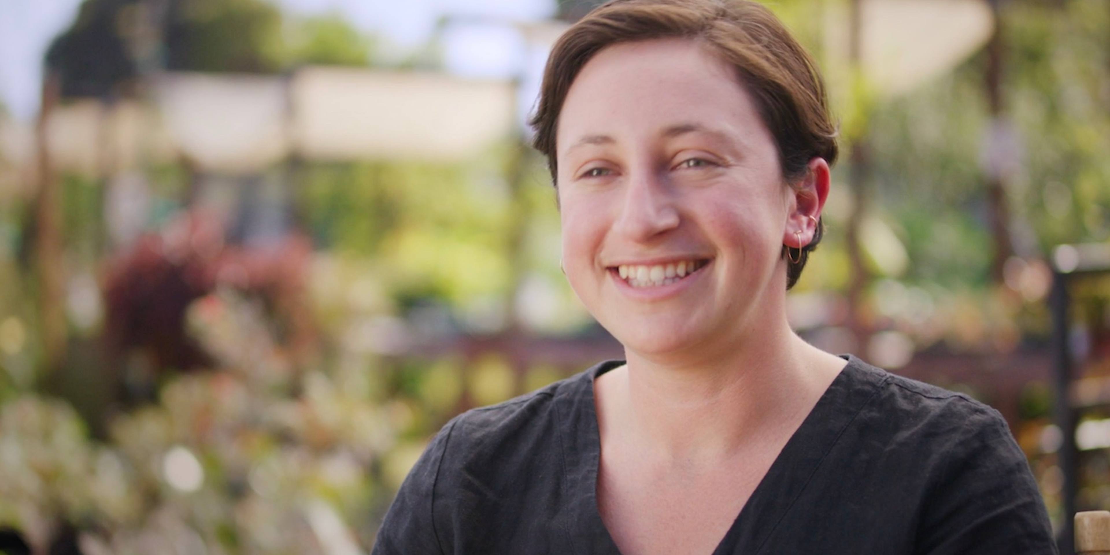 Frame of video showing Maddy Rotman of Imperfect Foods speaking on a farm