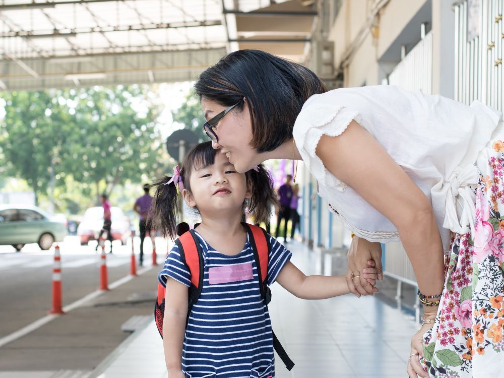 Mother sending her child off for school