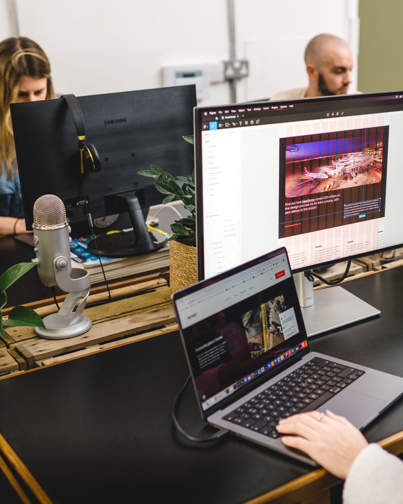 A website design open on a desktop monitor and a laptop at a studio desk. User interface design, Experience Design.