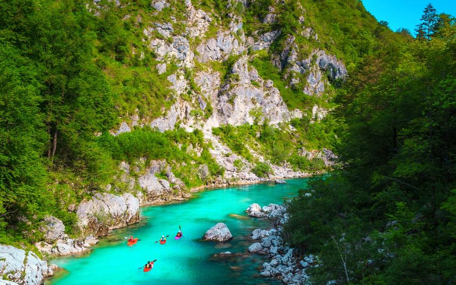 Kayakers on the emerald Soča river near Kobarid, Slovenia