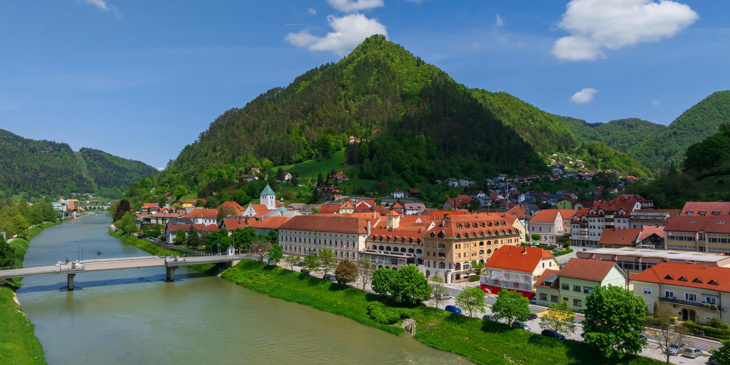 Laško and its stone bridge over the emerald Savinja river from above