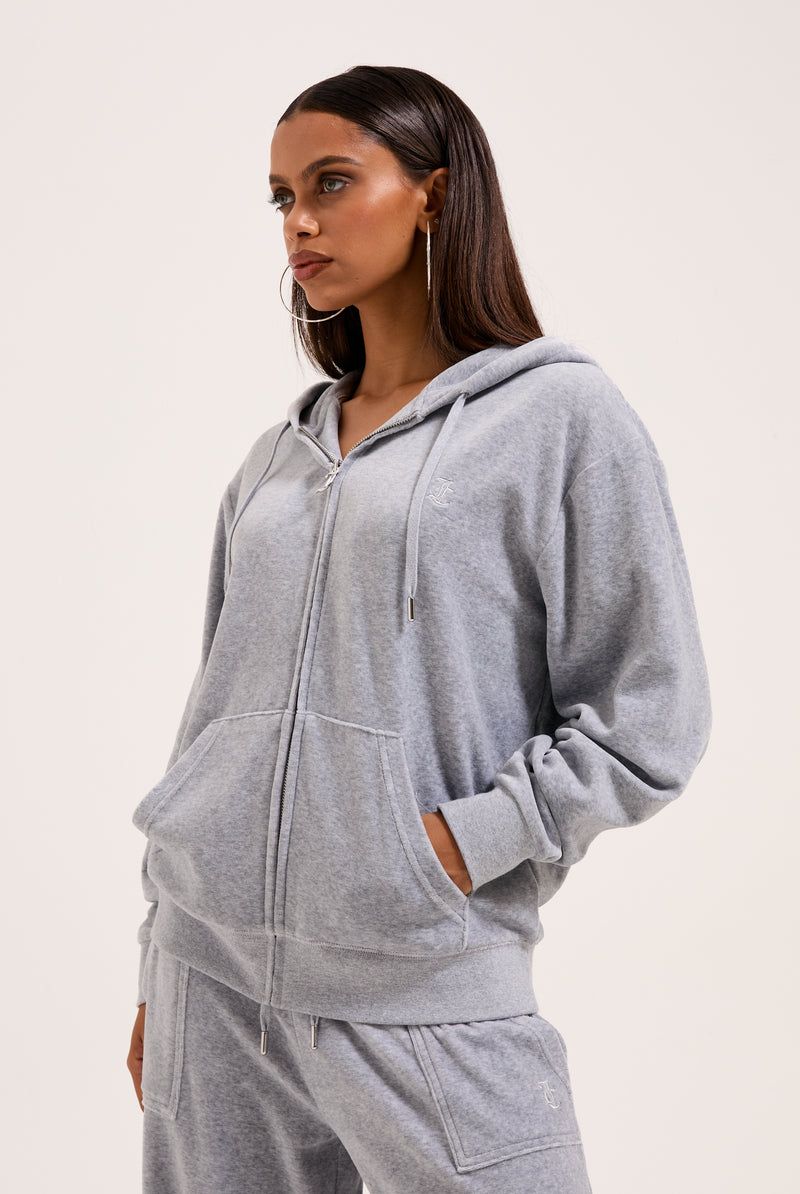 Model wearing Juicy Couture silver marl oversized hoodie and wide-leg track pants from the Forever Collection Model wearing Juicy Couture silver marl oversized hoodie and wide-leg track pants from the Forever Collection