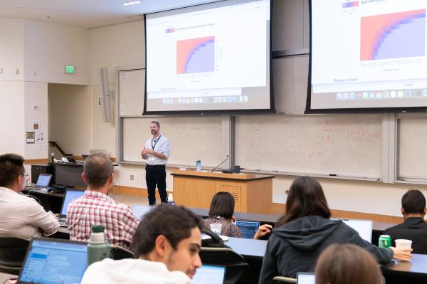 DS3 instructor presenting in front of students in a classroom