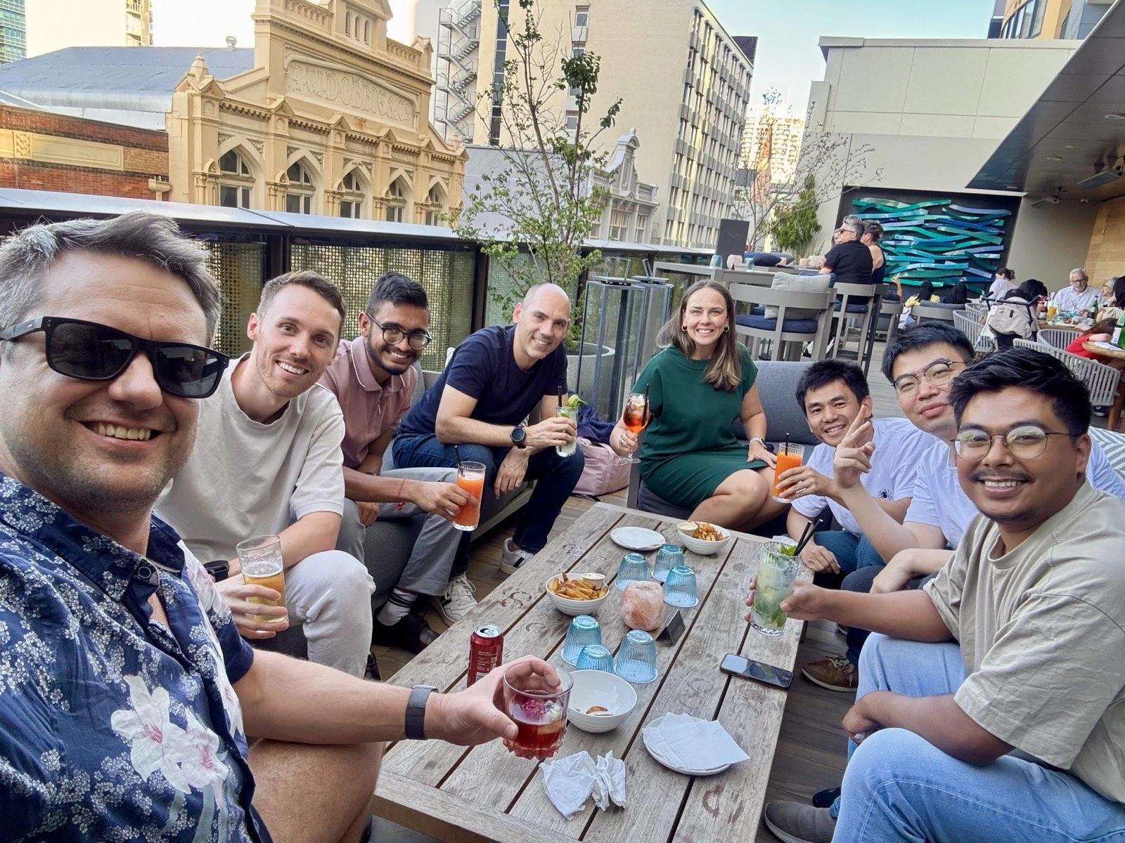 Travis Clapp taking a selfie with the Coursebox team over drinks on a rooftop terrace