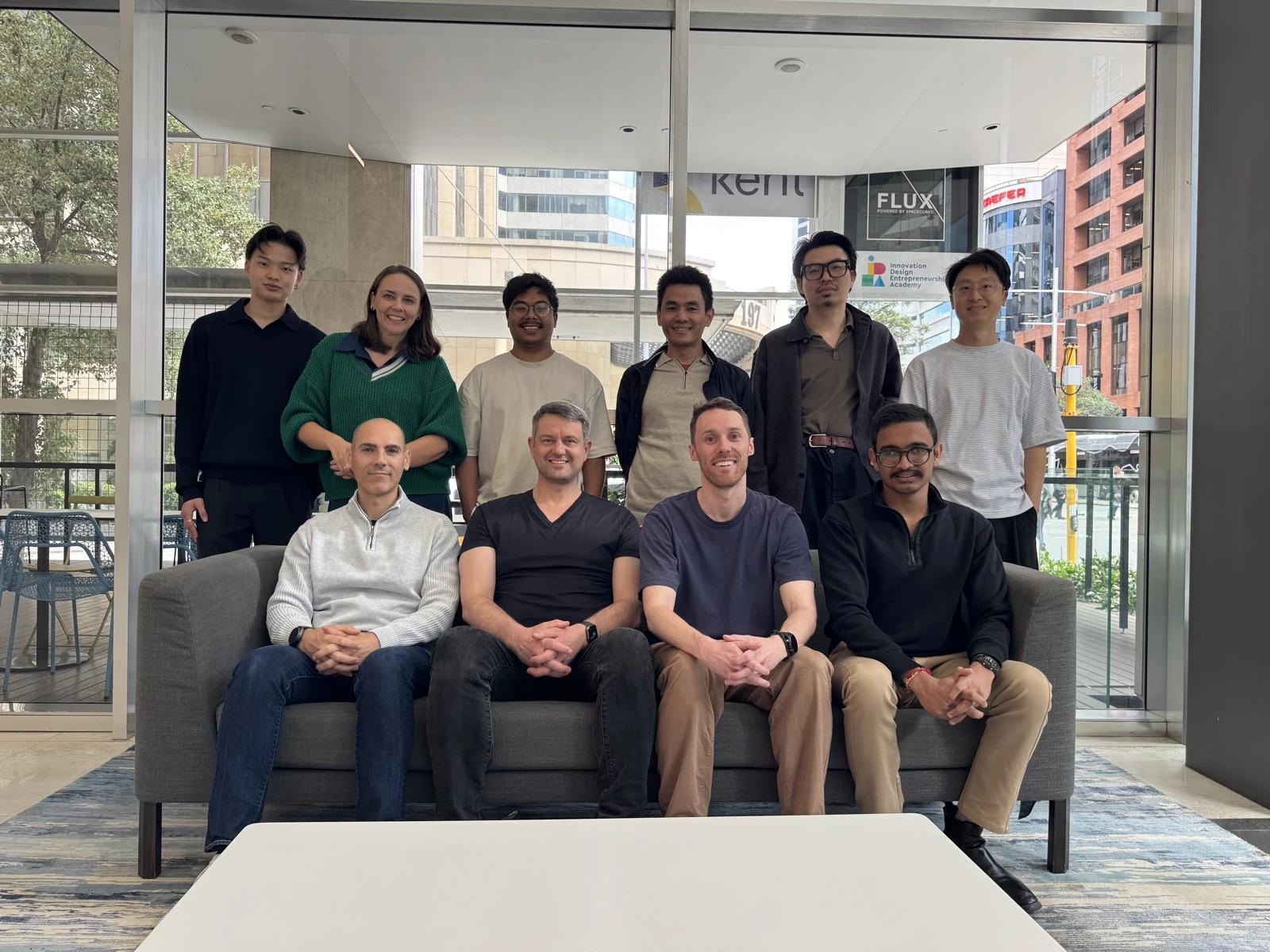 The Coursebox team together on and around a sofa in the Perth office foyer