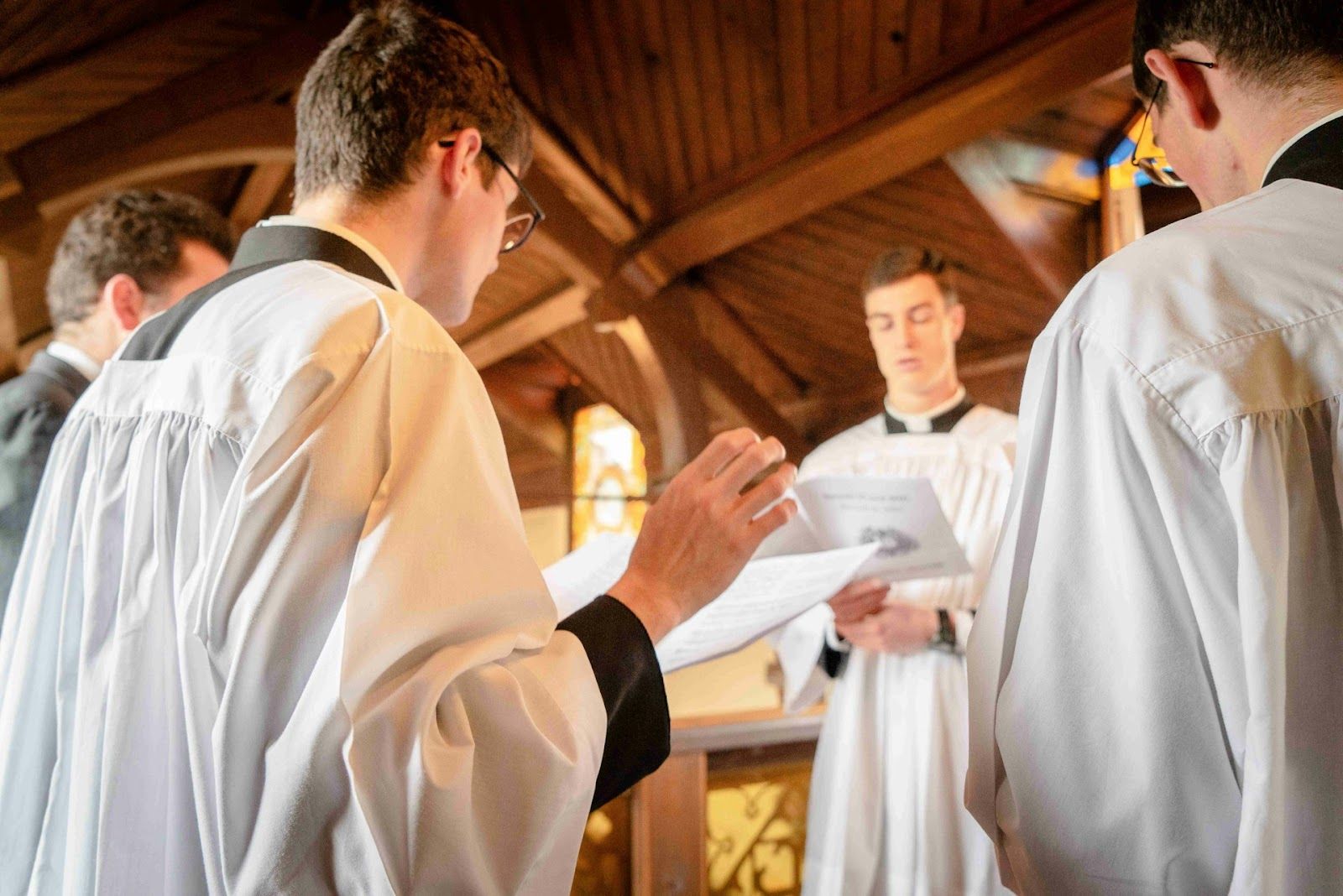 priests in church reciting together 