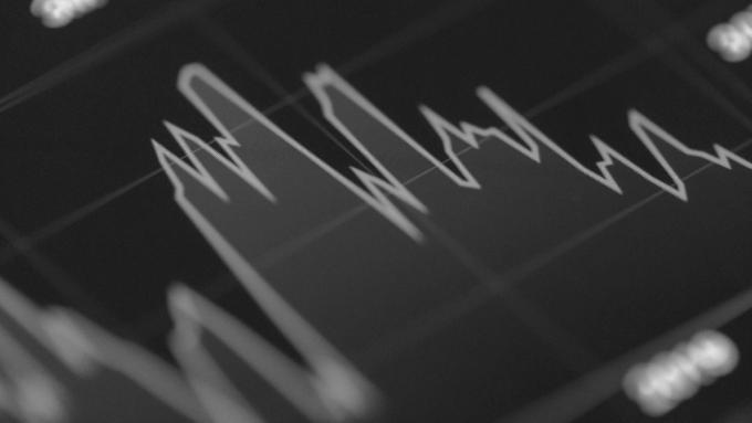 A financial line chart glowing on a dark screen