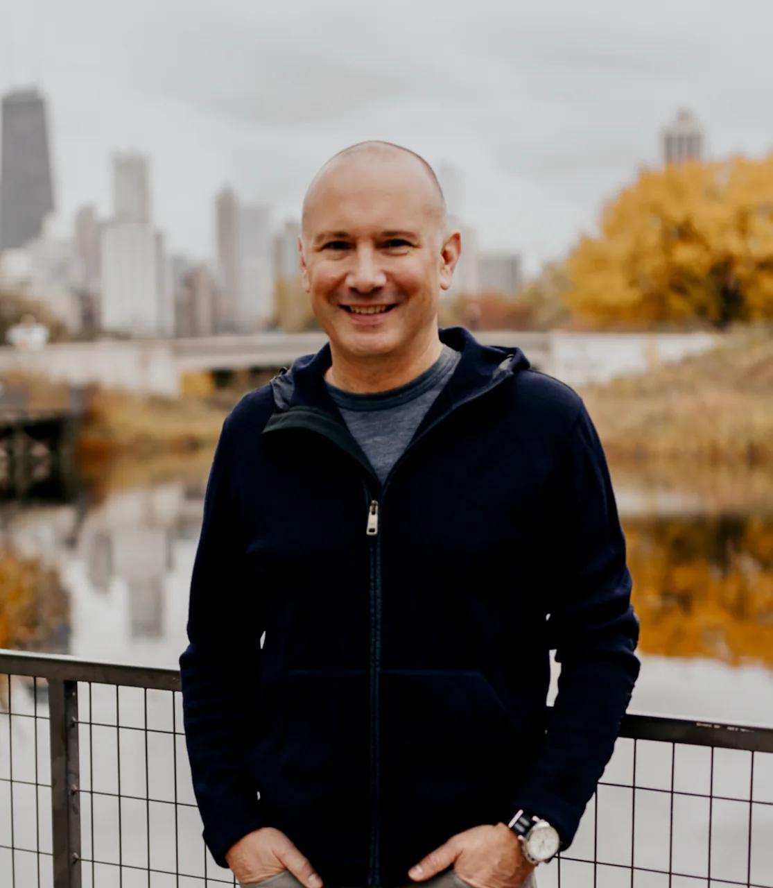 Steve Garrou standing outdoors with the Chicago skyline behind him