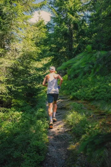 a person trail running in the woods