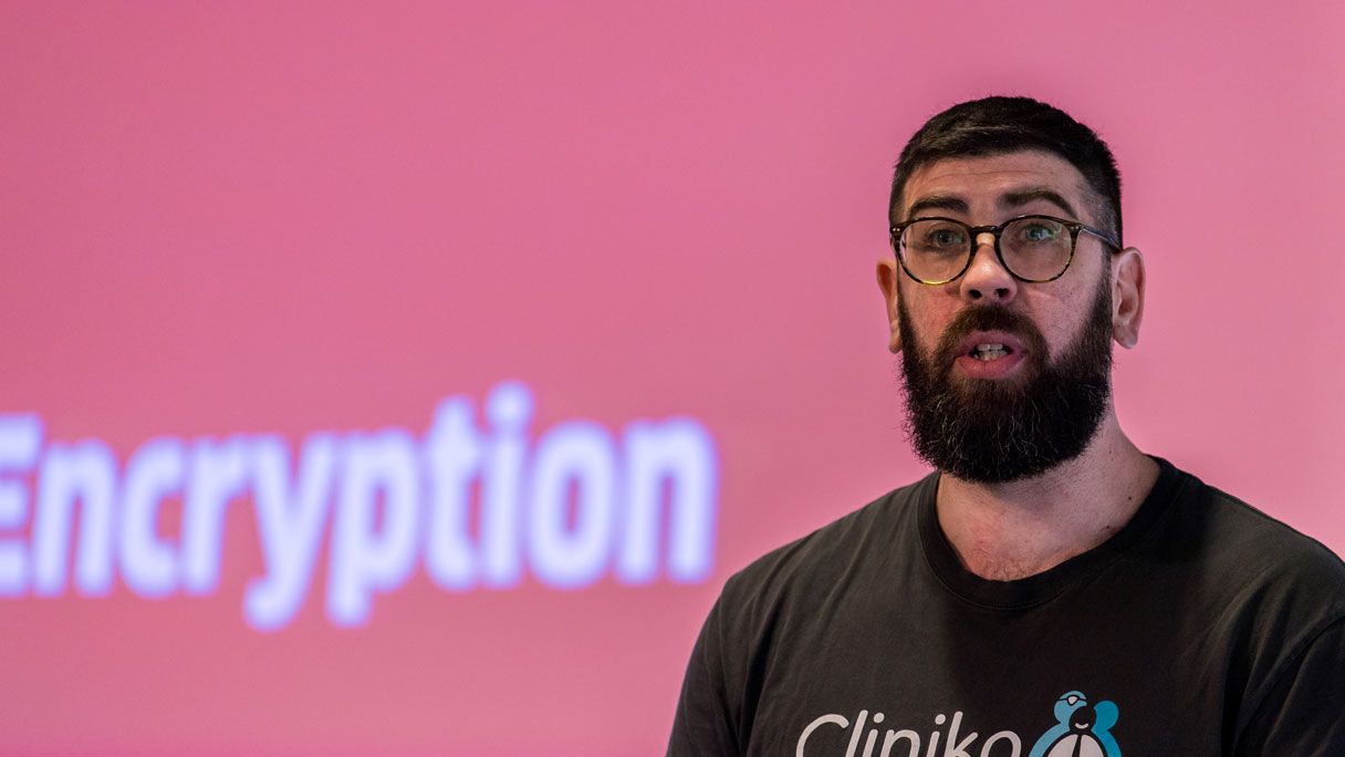 A still image from a video of Cliniko founder, Joel Friedlaender, giving a speech at a conference.