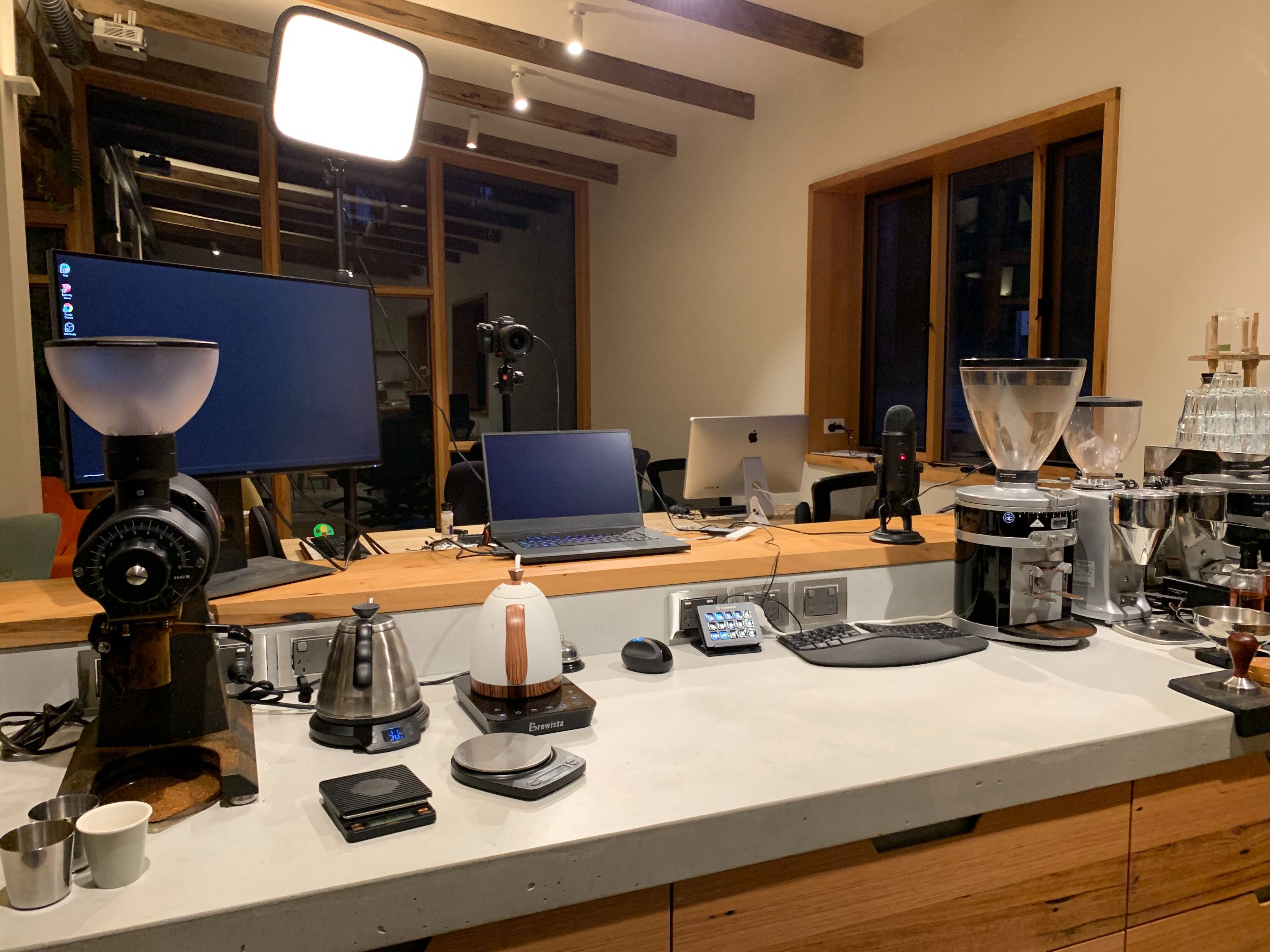 Joel's coffee bar set up at night, featuring all his coffee making tools and broadcast equipment
