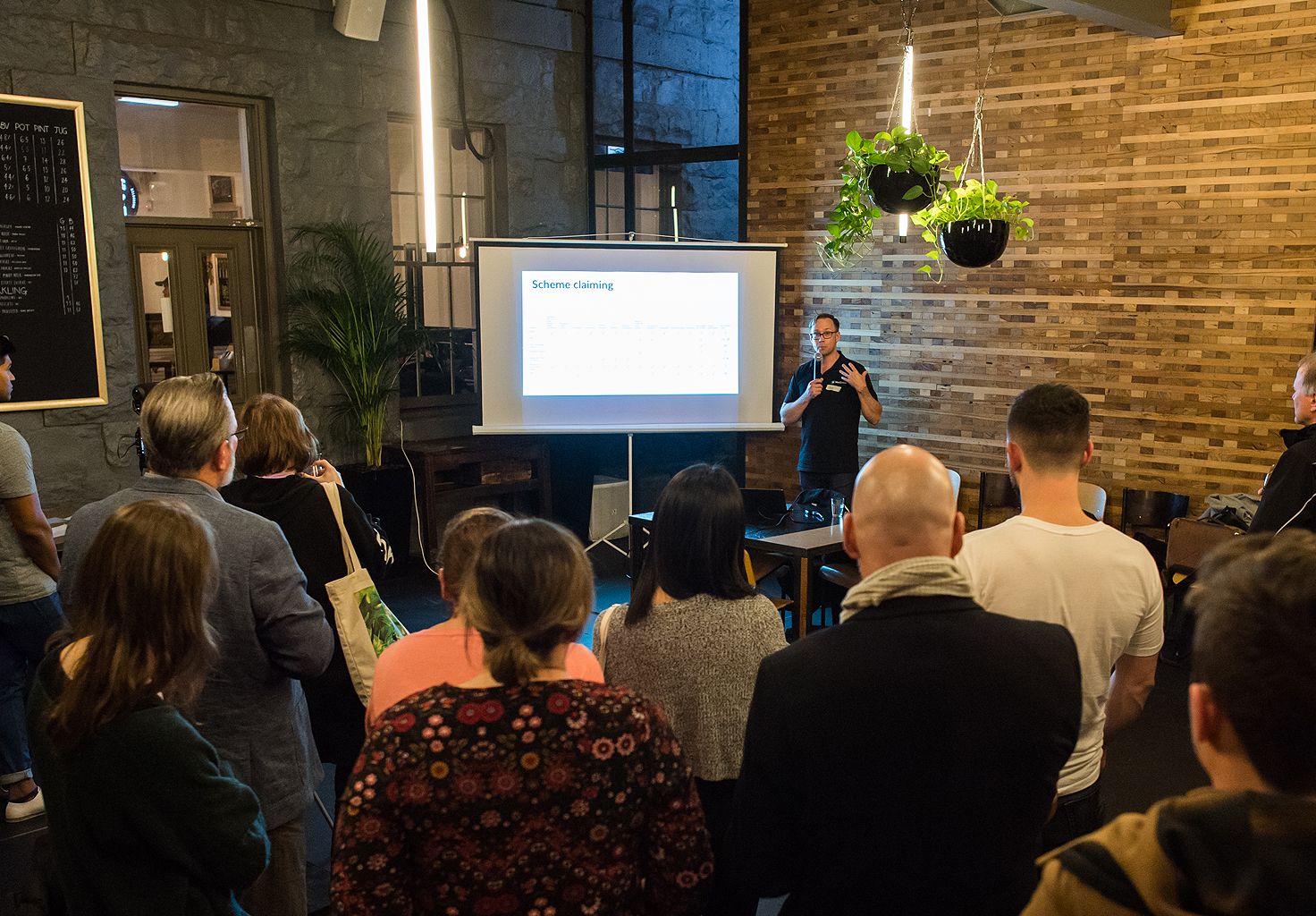 A photo of a person giving a presentation to an audience at the first Cliniko Community meetup in Melbourne.