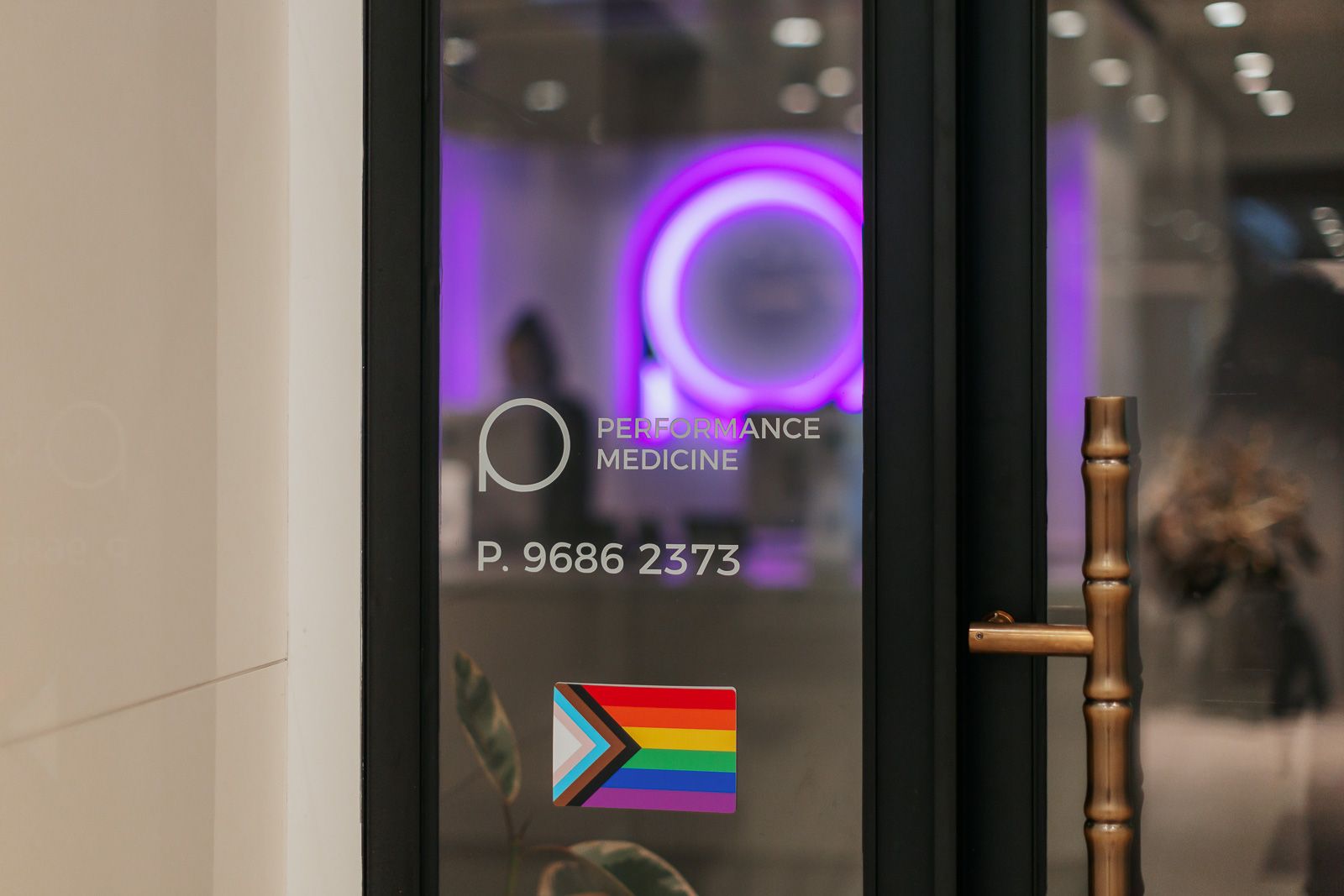 Business door with LGBTQIA+ flag