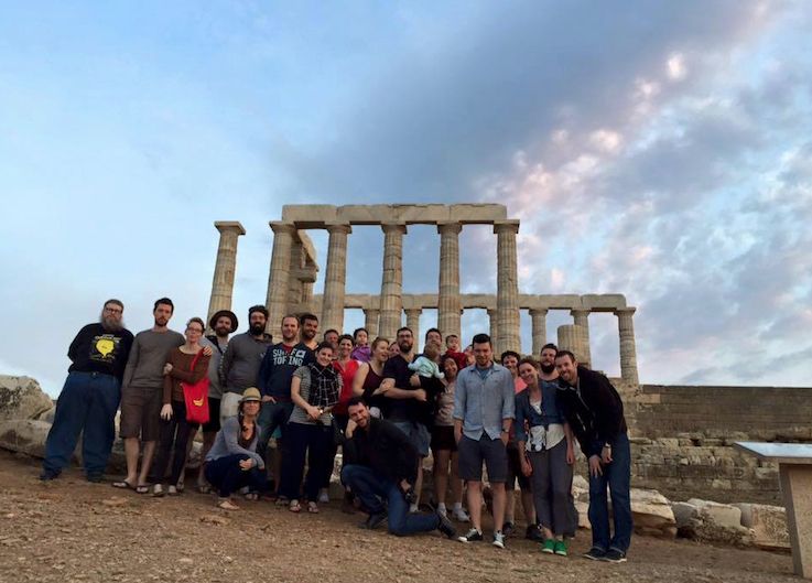 The cliniko team in Greece standing in front of some ancient ruins