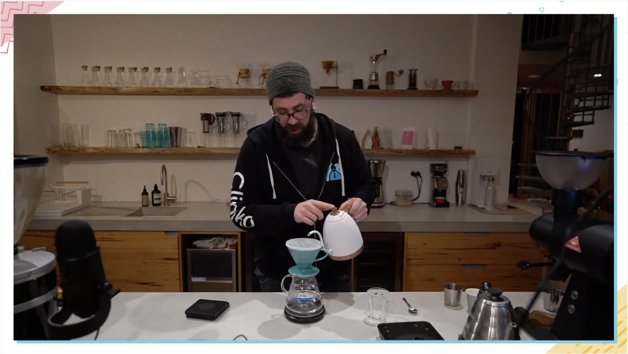 A screenshot of Joel pouring hot water from a kettle into his V60 to brew pour over coffee