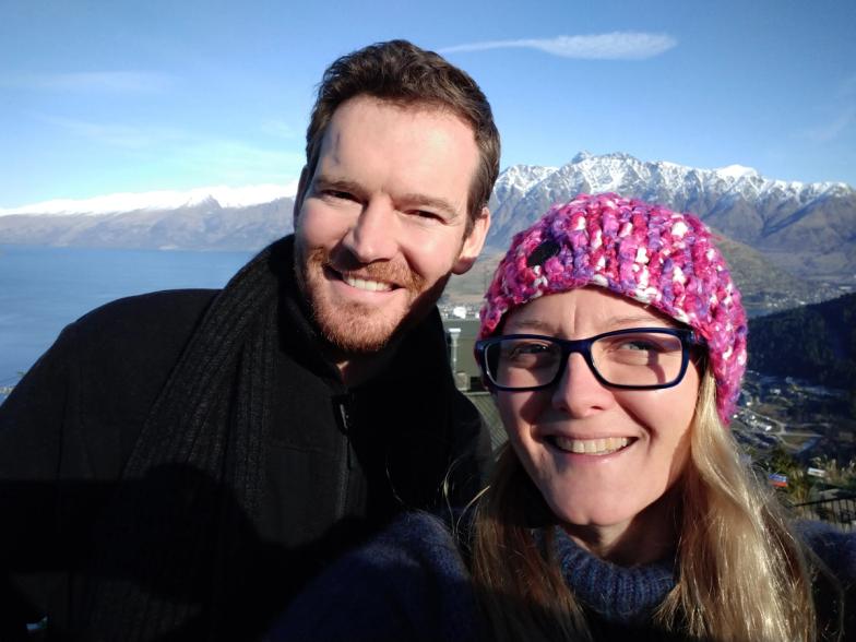 Annastashia Cambridge and Dr. Dan of Two Hands Health Ltd pictured standing in front of a snow-capped mountain range in New Zealand
