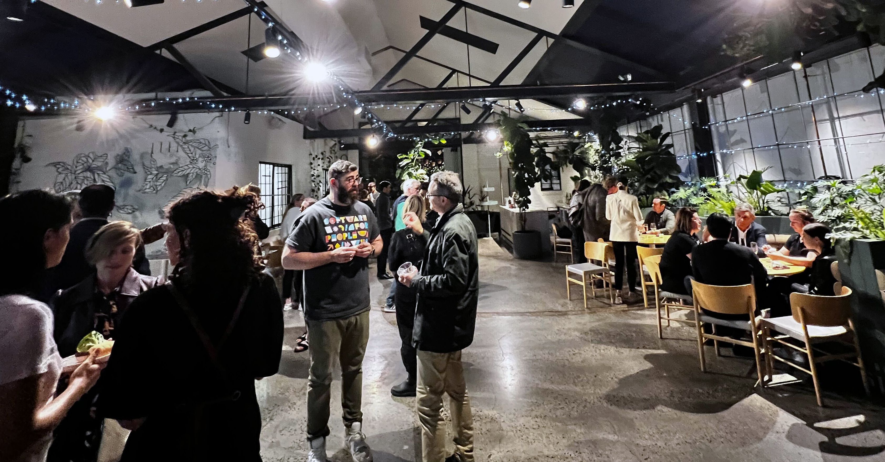 Photo of our founder Joel talking to a guest at our recent community meet up in Melbourne