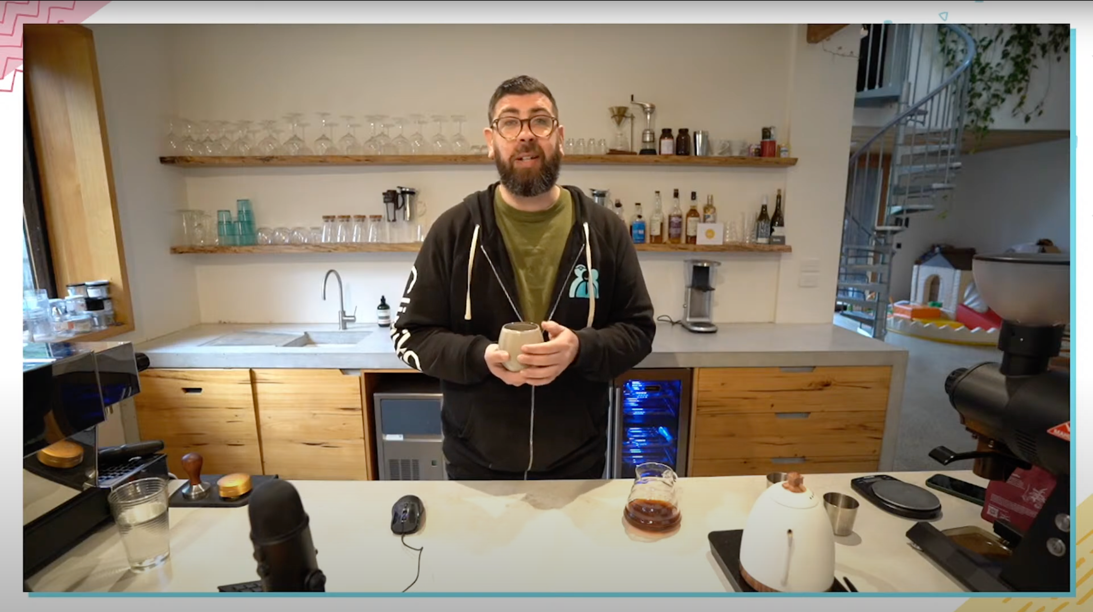 Joel standing at his home coffee bar answering questions from Cliniko and Coffee viewers
