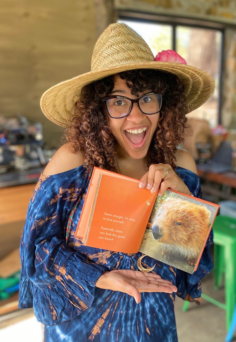 Rachel posing with a book about her favourite Aussie animal, wombats