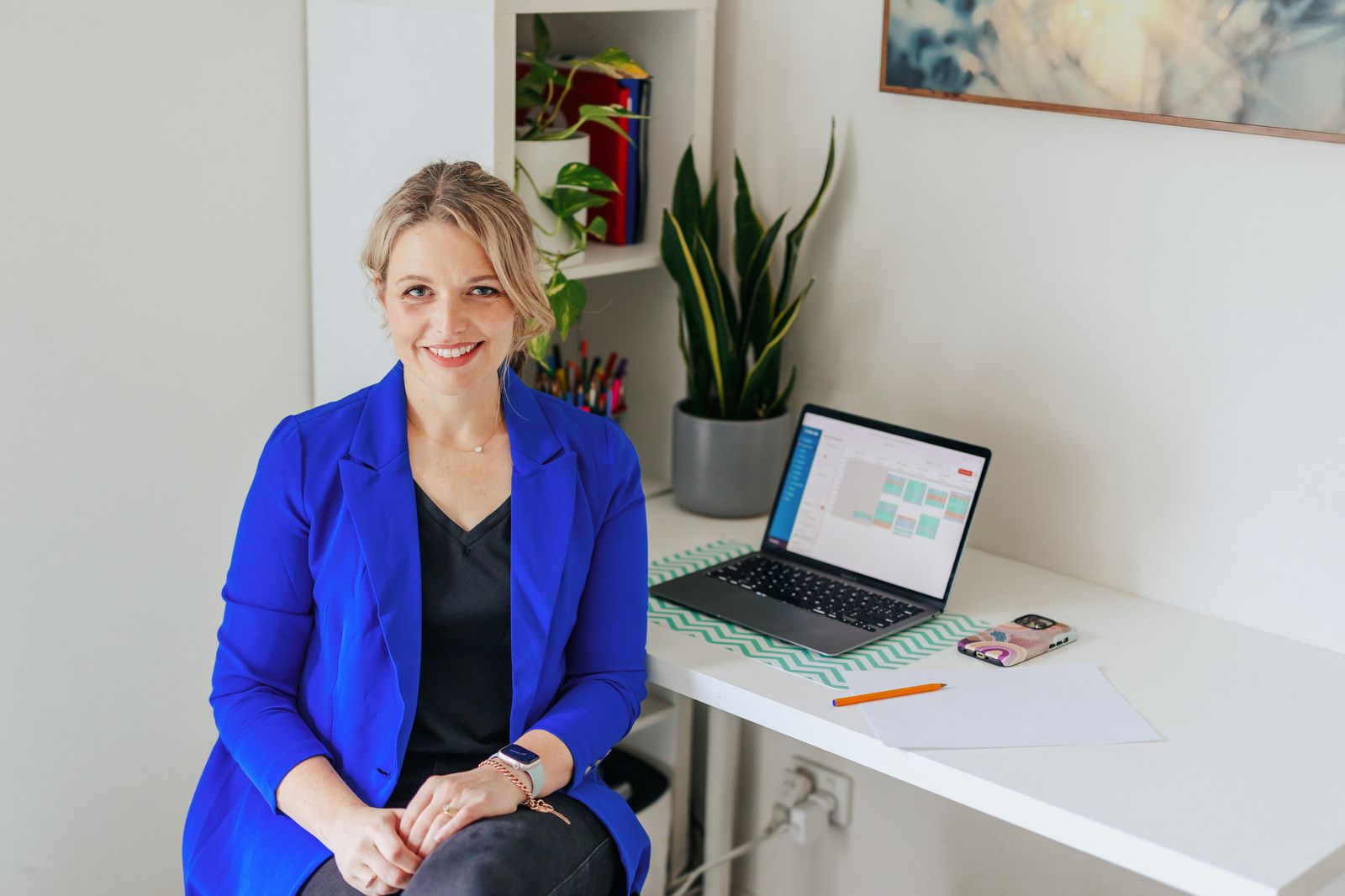 Kim Archer, co-owner of Complete Communication Speech Pathology, posed sitting in front of her laptop computer
