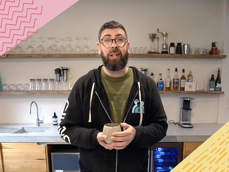 Joel standing at his home coffee bar answering questions from Cliniko and Coffee viewers