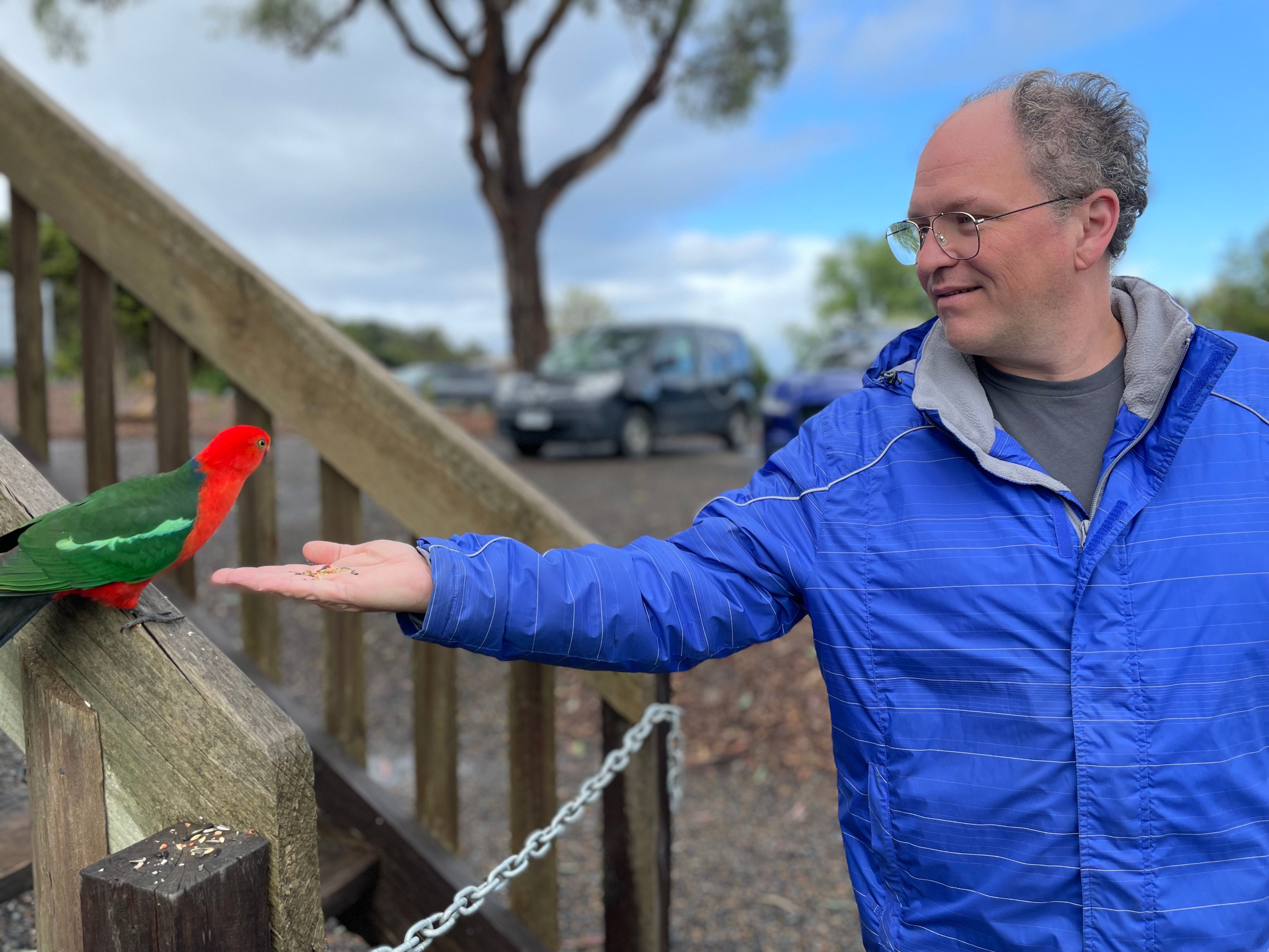 Bill feeding a parrot in Healesville