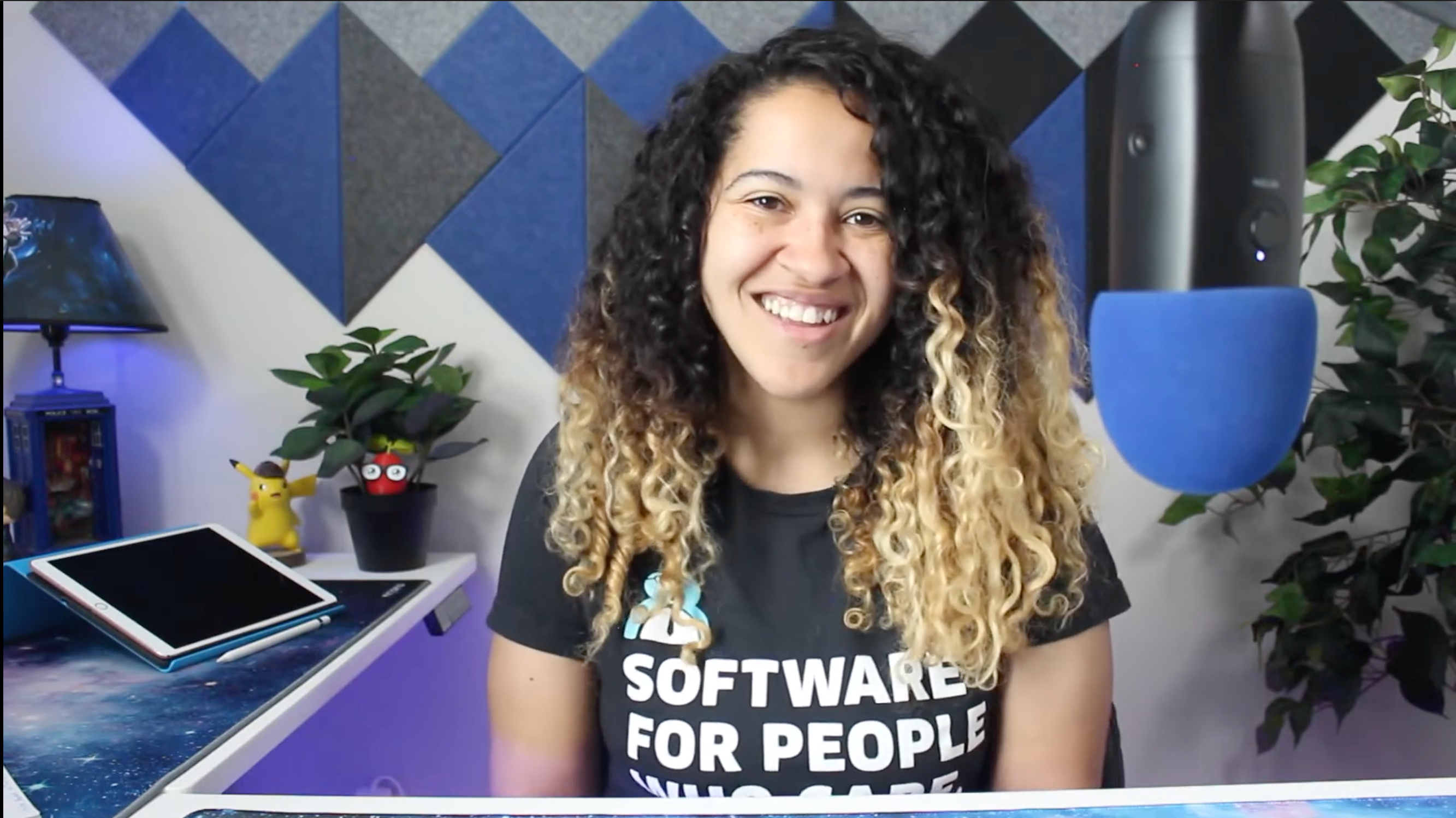 A screenshot of Rachel in her office wearing a Cliniko shirt that says 'Software for people who care'