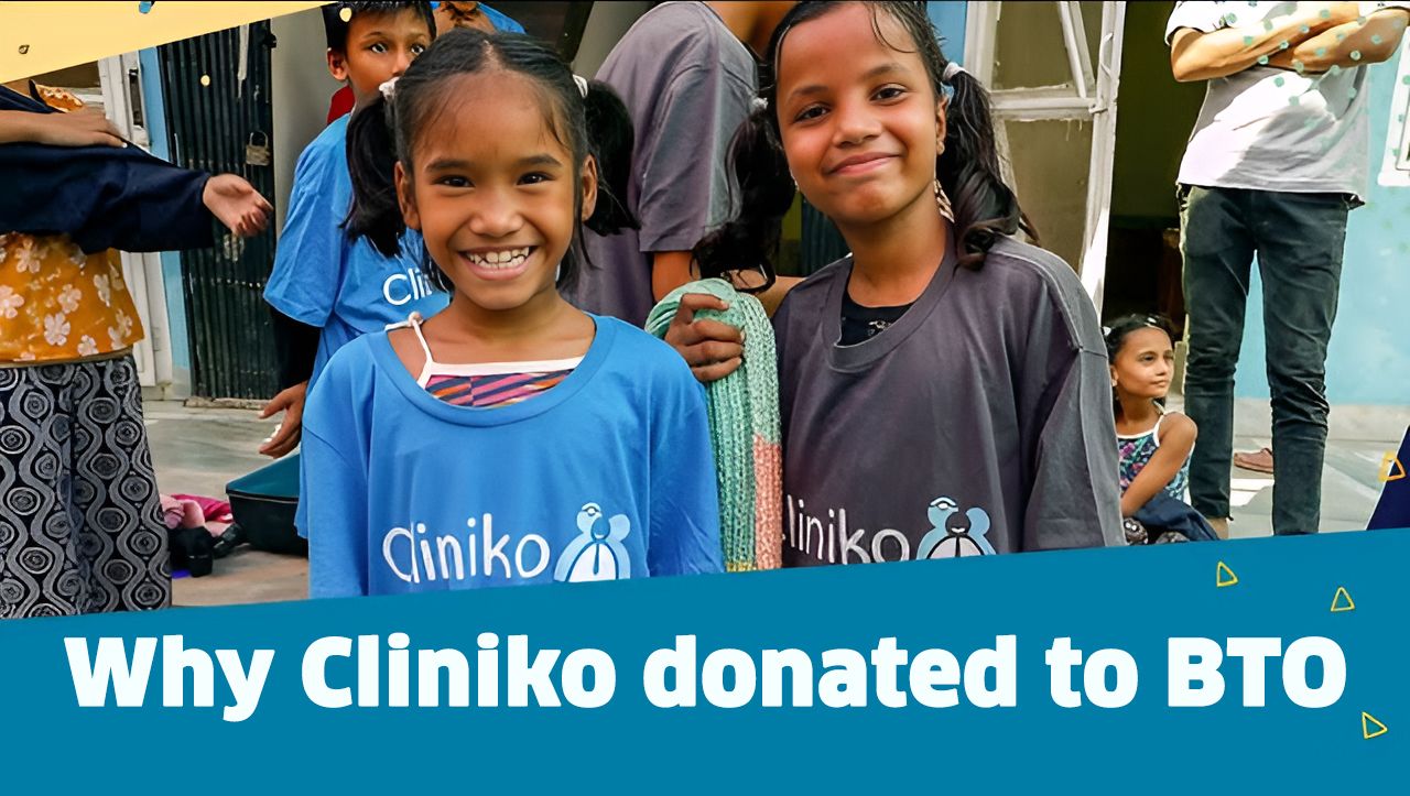 A photo of two smiling girls from Beyond the Orphanage wearing Cliniko t-shirts