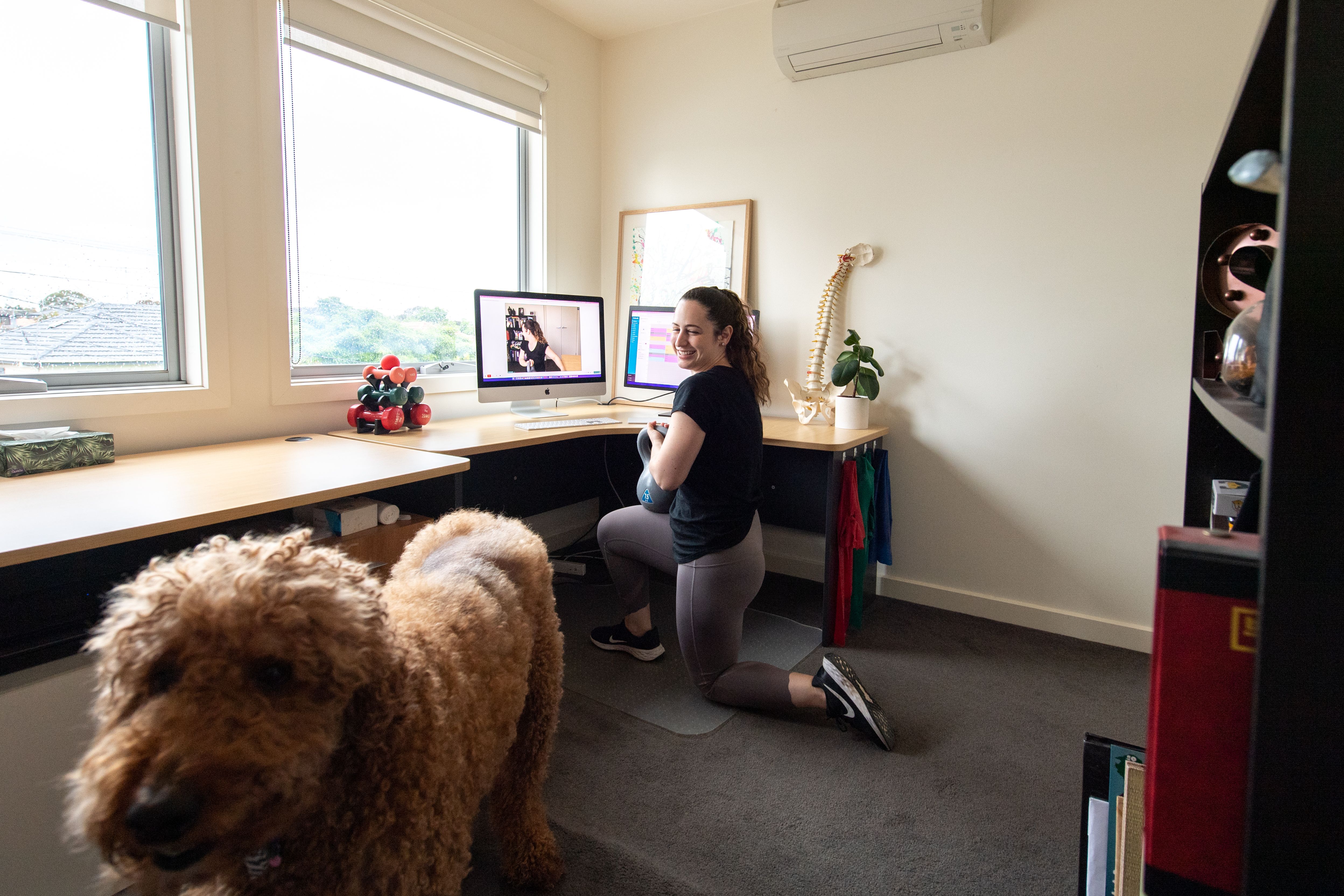 Simone Muscat in her home practice with her dog, Theo.