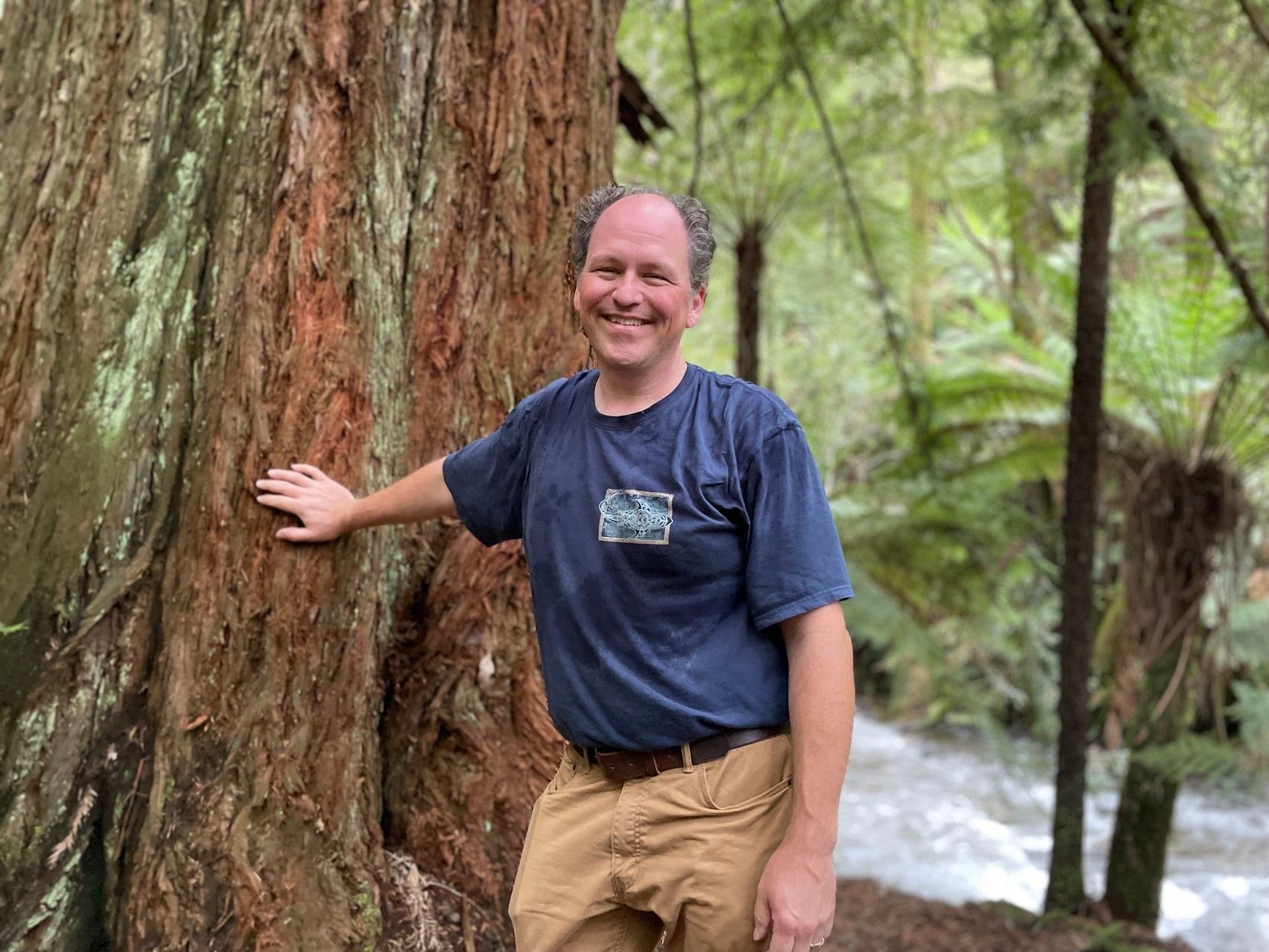 Bill Heller pictured posing in front of a tree
