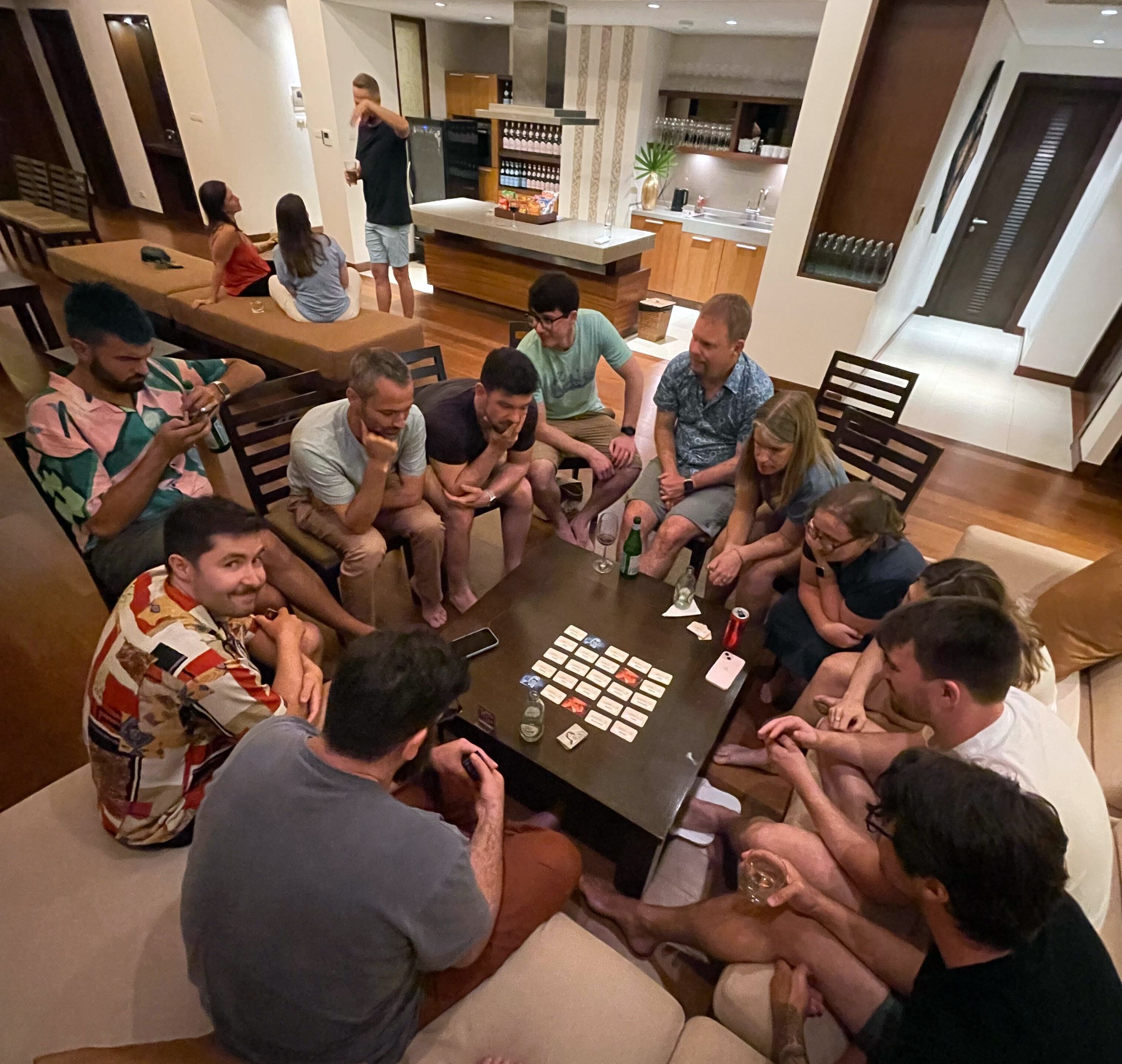 A photo of a large group of people playing an intense card game