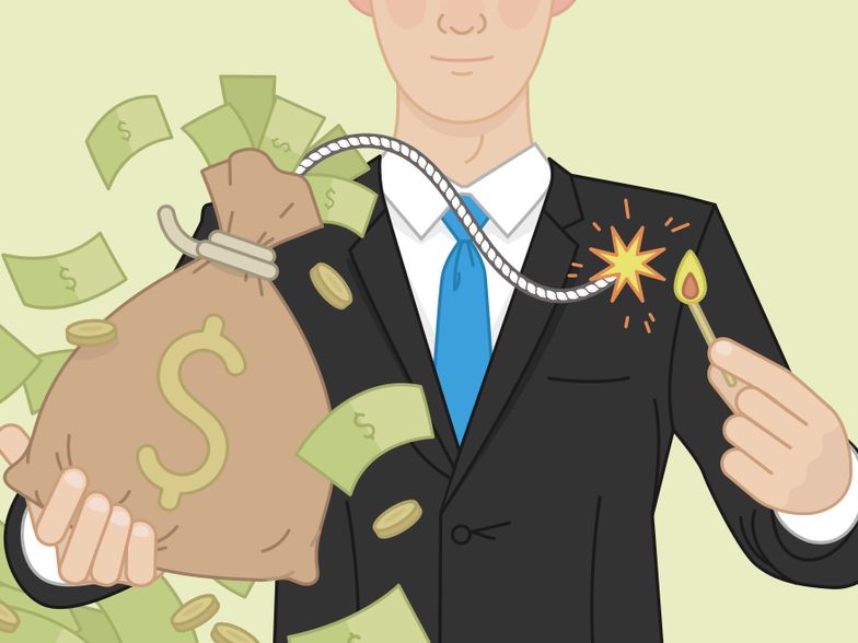 Man in a business suit lighting a fuse to a bag of money