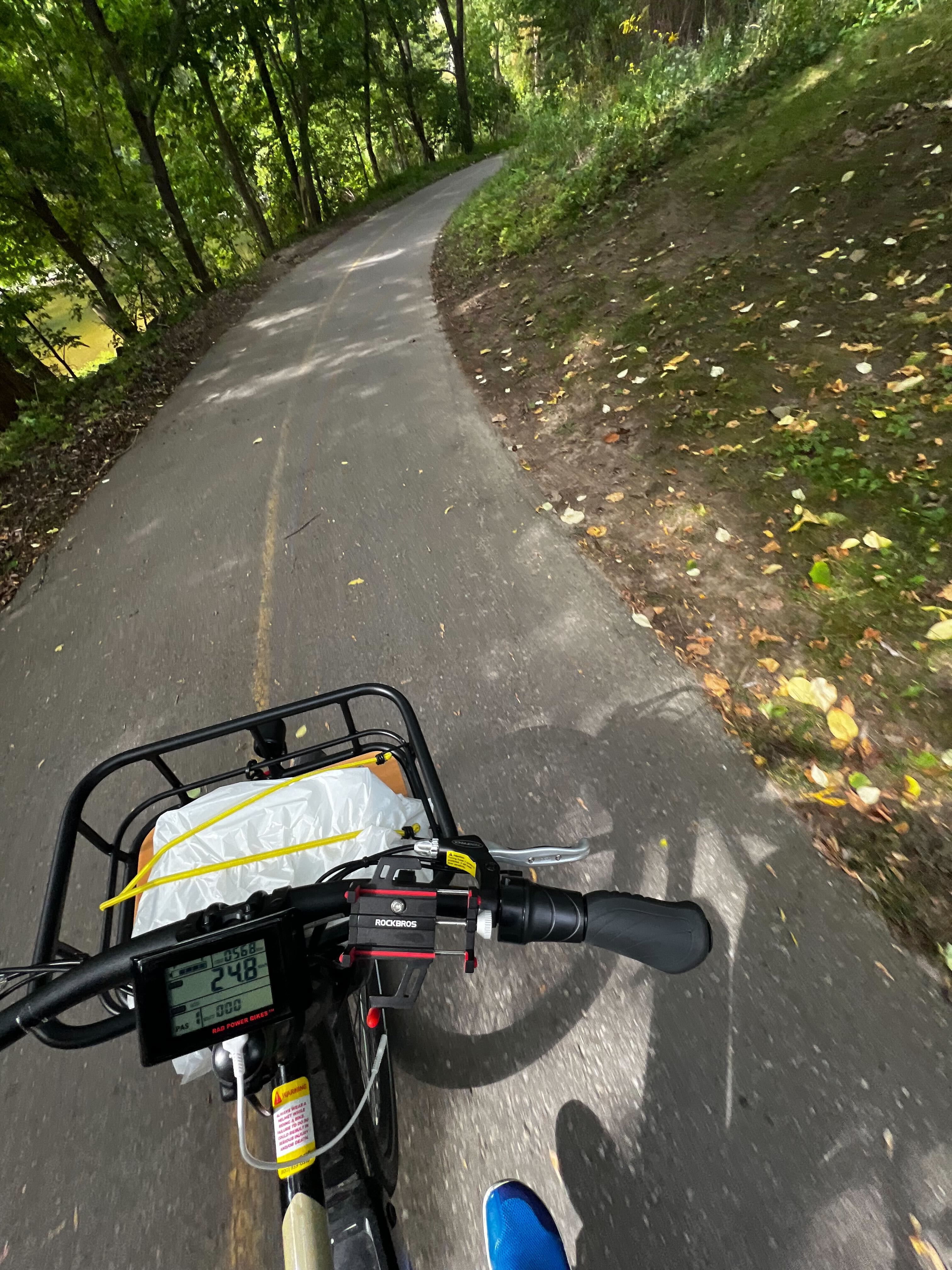 A photo taken from the bike seat on a ride through the forest