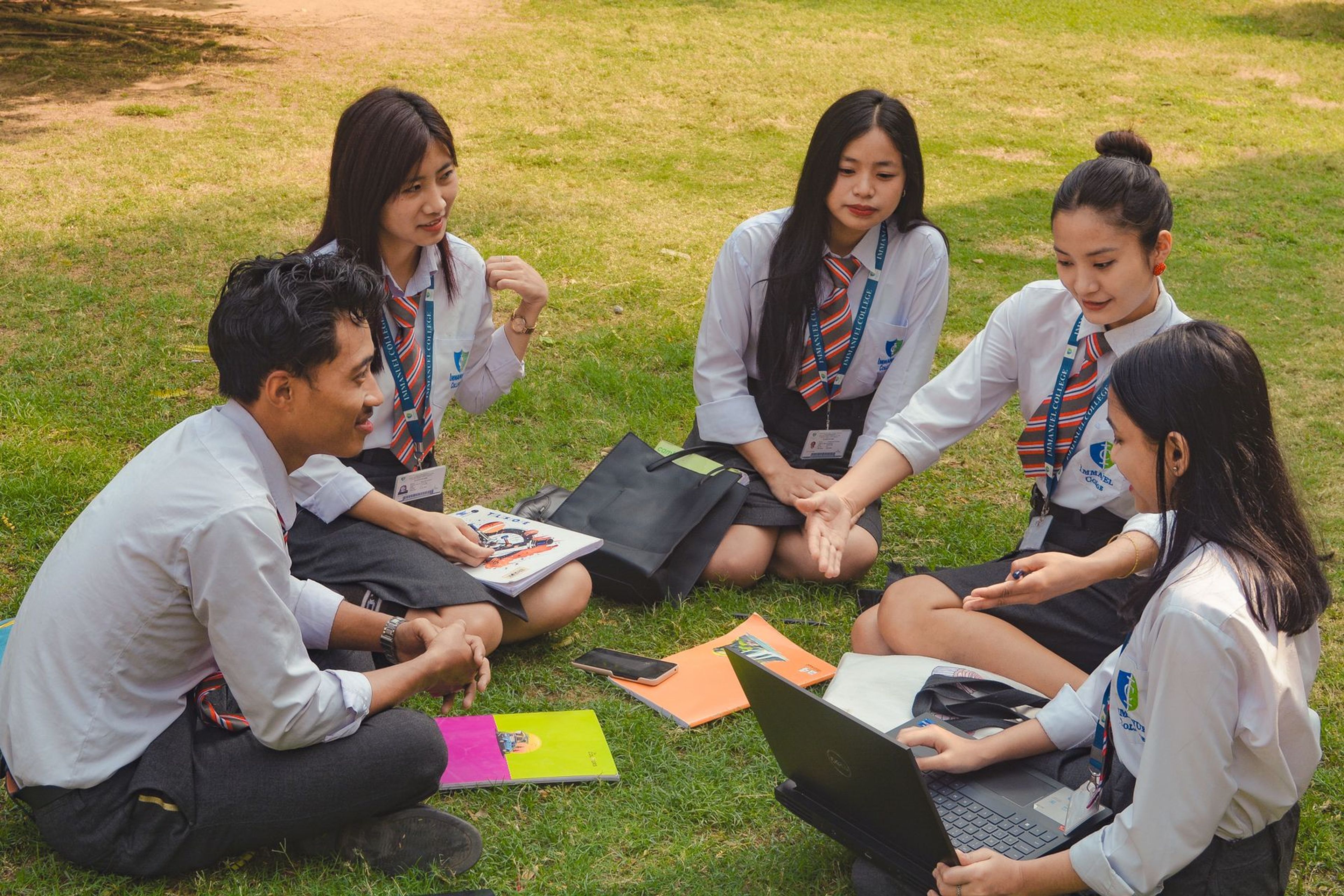 Students collaborating outdoors on a sunny day